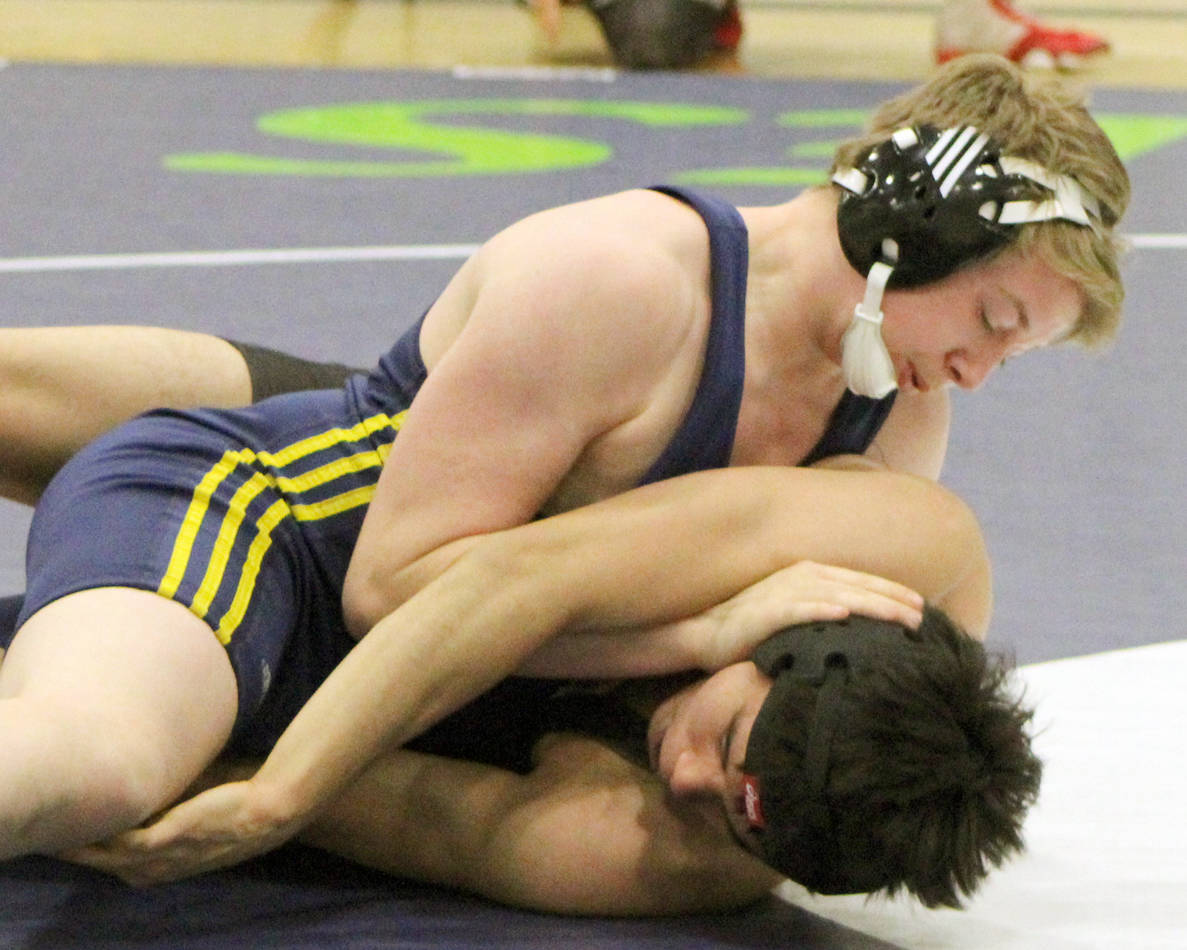Homer’s Edson Knapp works to turn Seward’s Lucas Brockman during a consolation match at 171 pounds on the first day of the Kachemak Conference Championships Friday, Dec. 13, 2019, at Redington Jr/Sr High School. (Photo by Tim Rockey/Frontiersman)