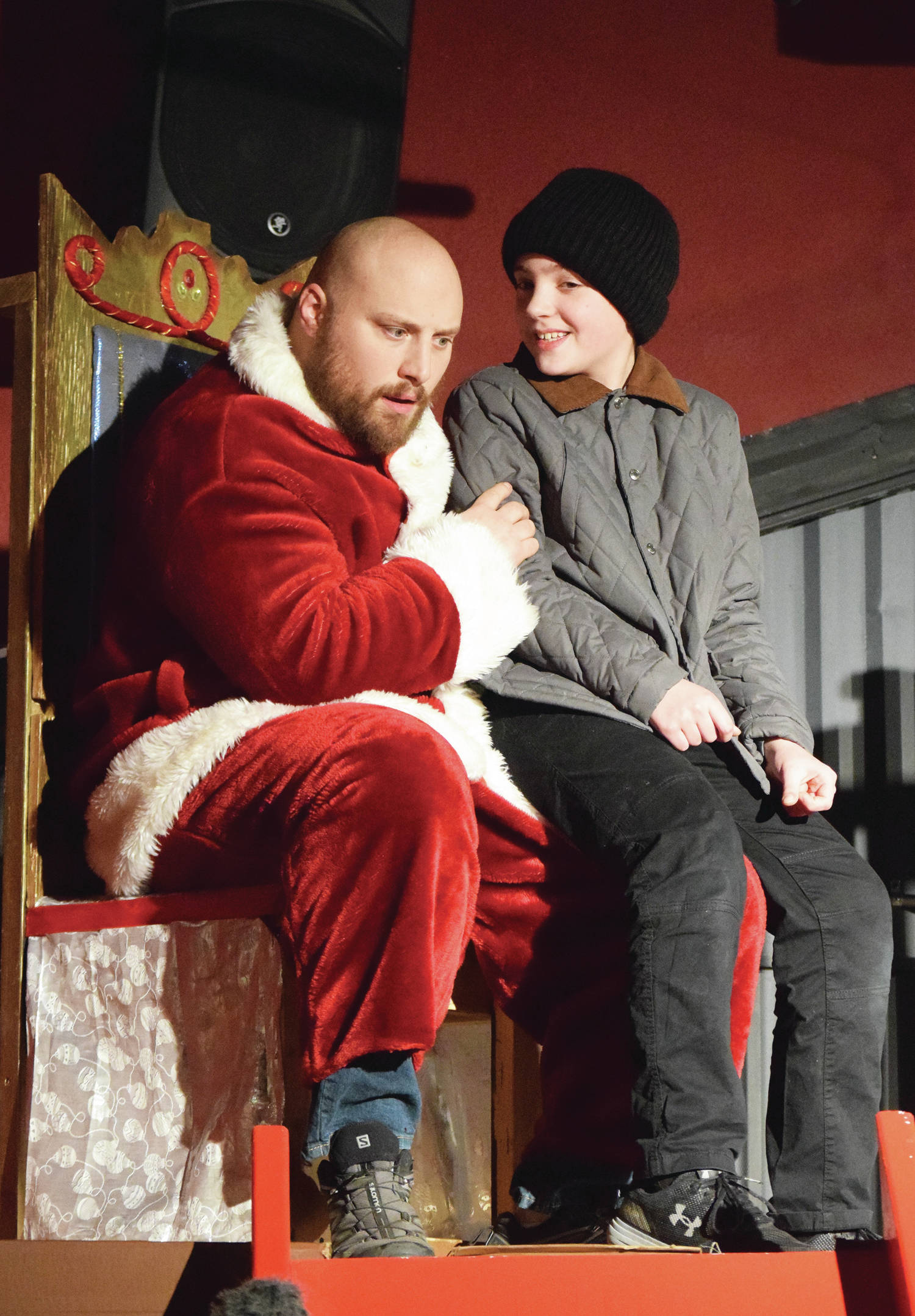 Tyler Payment (left) acts out a scene with a young actor Tuesday, Dec. 17, 2019, at a rehearsal of “A Christmas Story” by the Triumvirate Theatre North in Kenai, Alaska. (Photo by Joey Klecka/Peninsula Clarion)