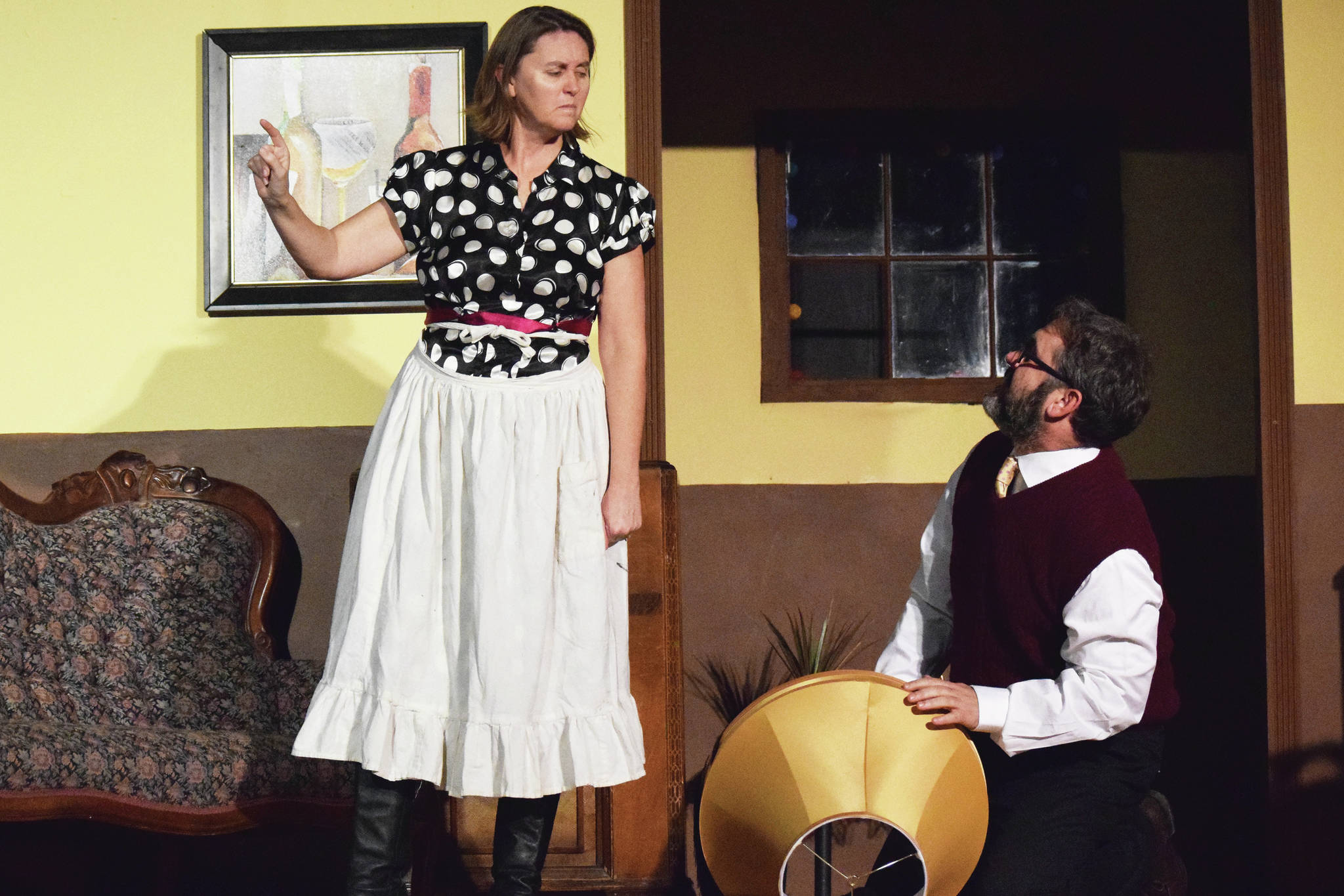 Carla (left) and Chris Jenness act out a scene Tuesday, Dec. 17, 2019, at a rehearsal of “A Christmas Story” by the Triumvirate Theatre North in Kenai, Alaska. (Photo by Joey Klecka/Peninsula Clarion)