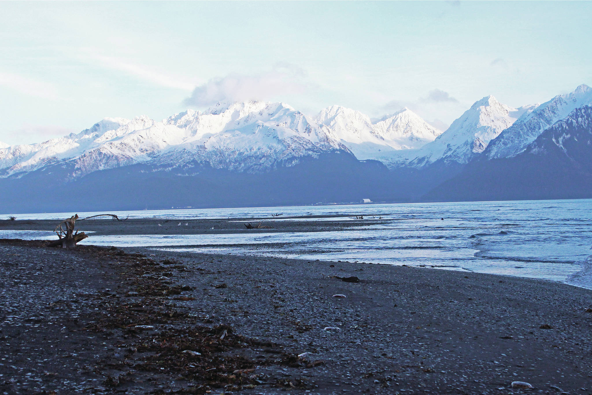 Sun reflects off snow covering the mountains across Resurrection Bay from the Tonsina Point area on Sunday, Dec. 8, 2019 near Lowell Point, Alaska. (Photo by Megan Pacer/Homer News)