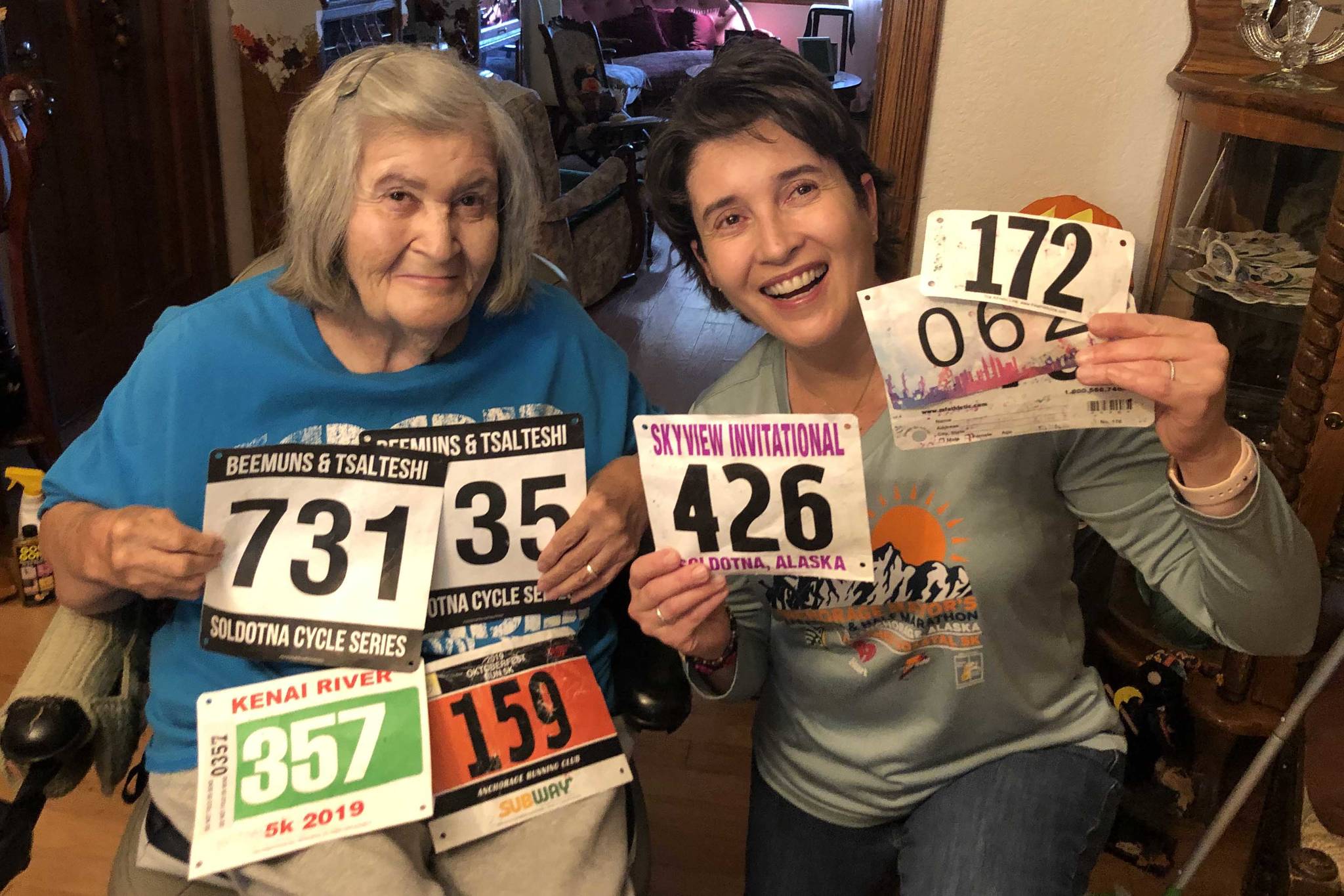 Salli Sterrett receives race bibs from her daughter, Sheilah-Margaret Pothast, in Arizona in late October. Pothast is doing 50 races in her 50th year for her mother. (Photo provided by Sheilah-Margaret Pothast)
