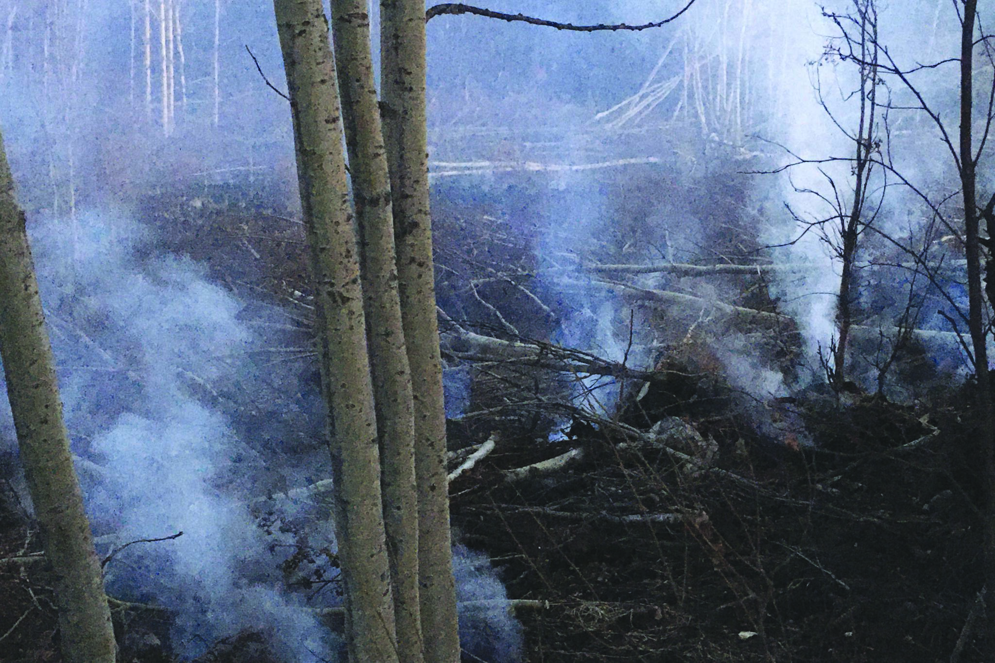 Smoke can be seen rising from areas scarred by the Swan Lake Fire on Sunday, Oct. 6, 2019 at Mile 10 of Skilak Loop Road, on Alaska’s Kenai Peninsula. (Photo by Jeff Helminiak/Peninsula Clarion)