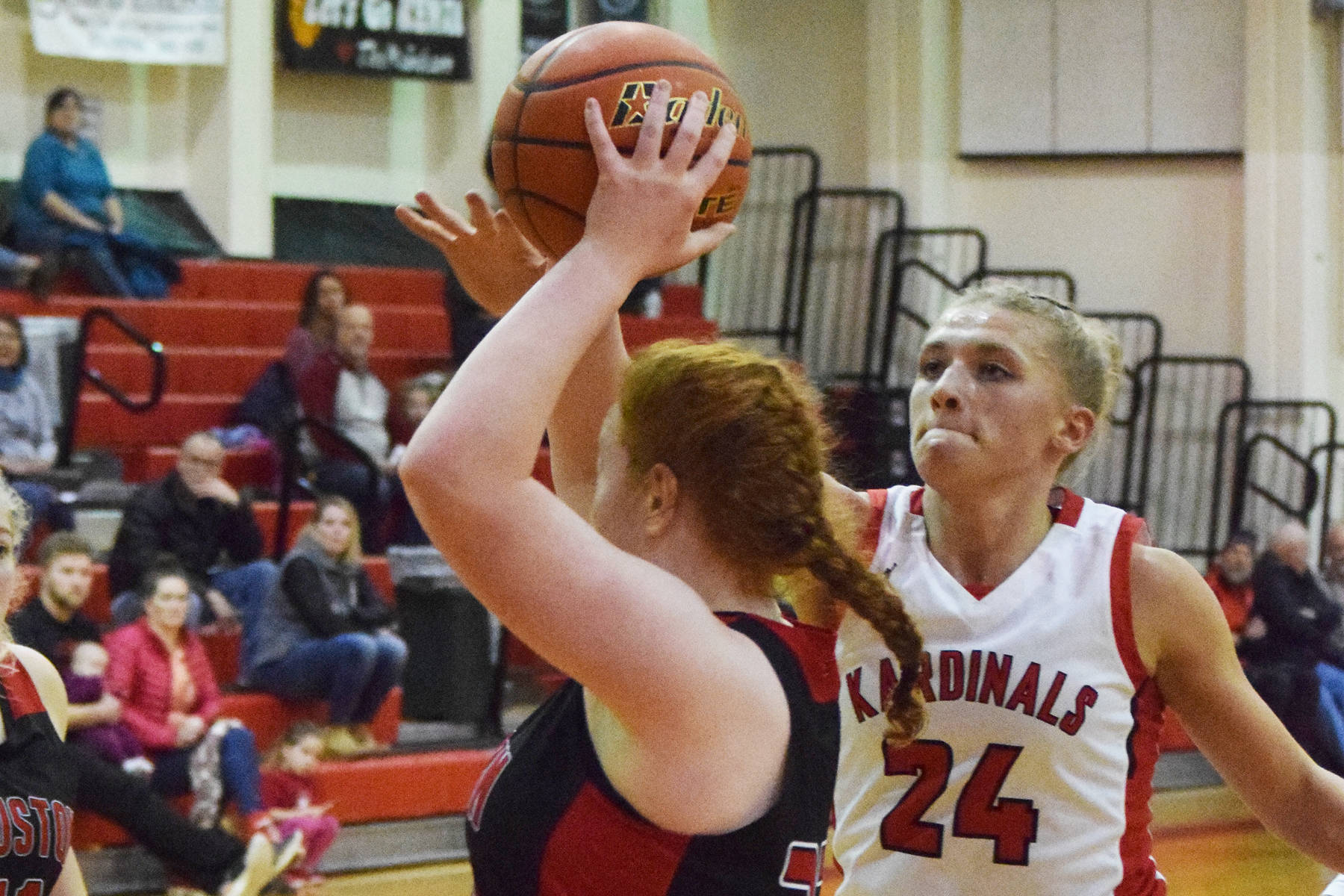 Kenai’s Damaris Severson (24) defends Houston’s Emily Bitler, Thursday, Dec. 19, 2019, at the Craig Jung Kenai River Challenge tournament at Kenai Central High School. (Photo by Joey Klecka/Peninsula Clarion)