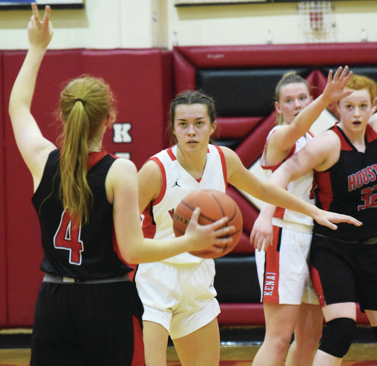 Kenai’s Logan Satathite keeps her eye on Houston’s Denali Whitted, Thursday, Dec. 19, 2019, at the Craig Jung Kenai River Challenge tournament at Kenai Central High School. (Photo by Joey Klecka/Peninsula Clarion)