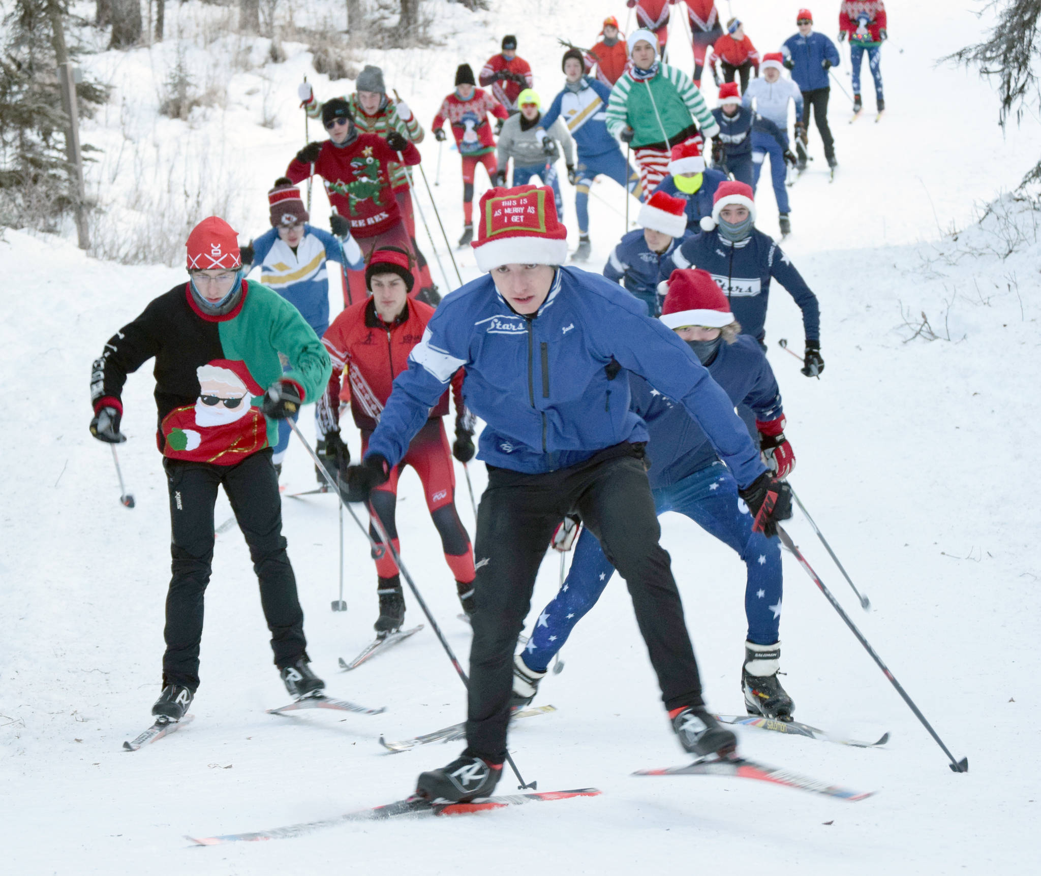 Soldotna’s Jack Harris leads racers up the first hill in the Candy Cane Scramble on Friday, Dec. 20, 2019, at Tsalteshi Trails near Soldotna, Alaska. (Photo by Jeff Helminiak/Peninsula Clarion)