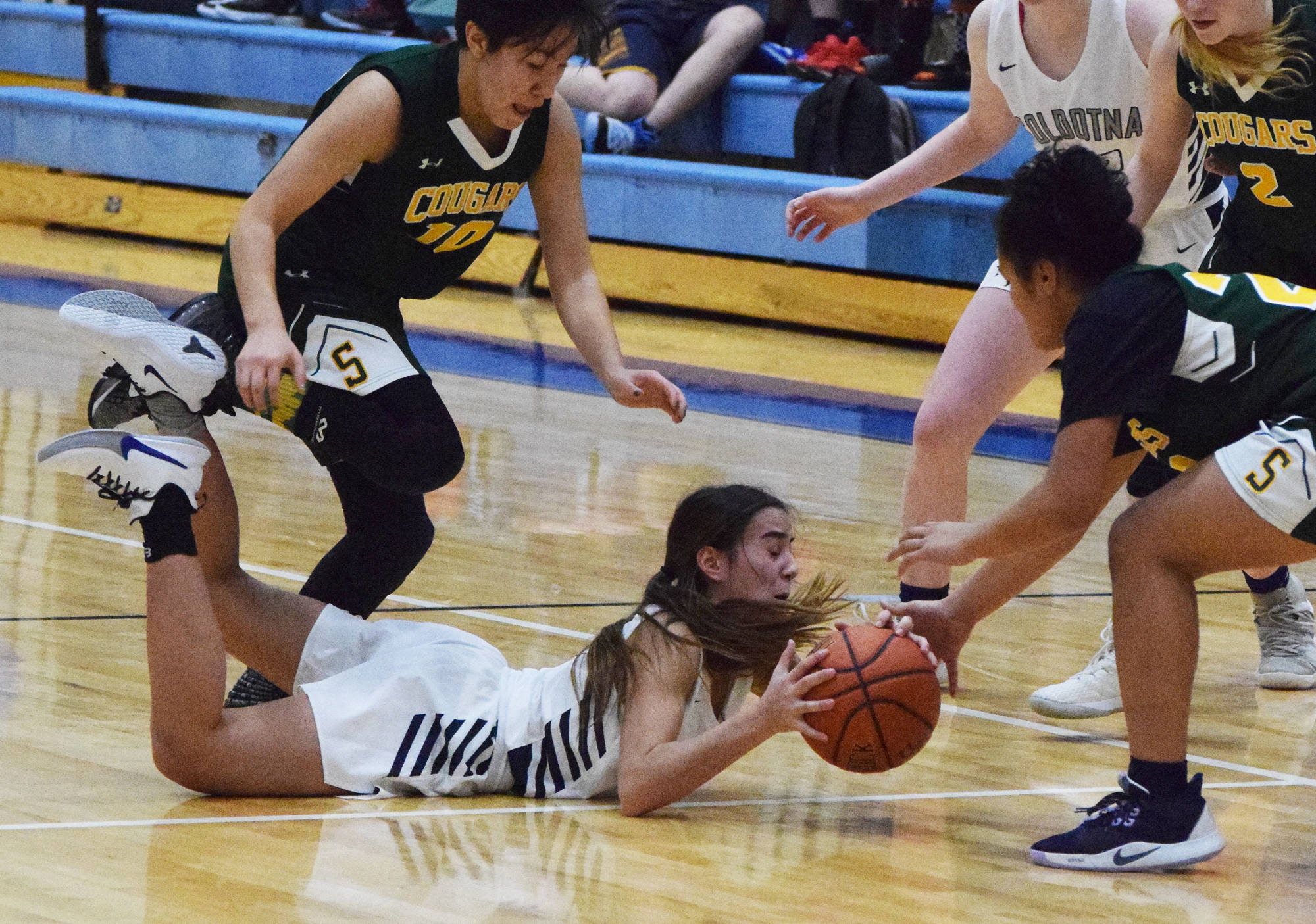 Soldotna’s Drysta Crosby-Schneider retains possesson of the ball after falling Friday, Dec. 20, 2019, against Service at the Powerade/Al Howard Tip-Off tournament at Soldotna High School. (Photo by Joey Klecka/Peninsula Clarion)