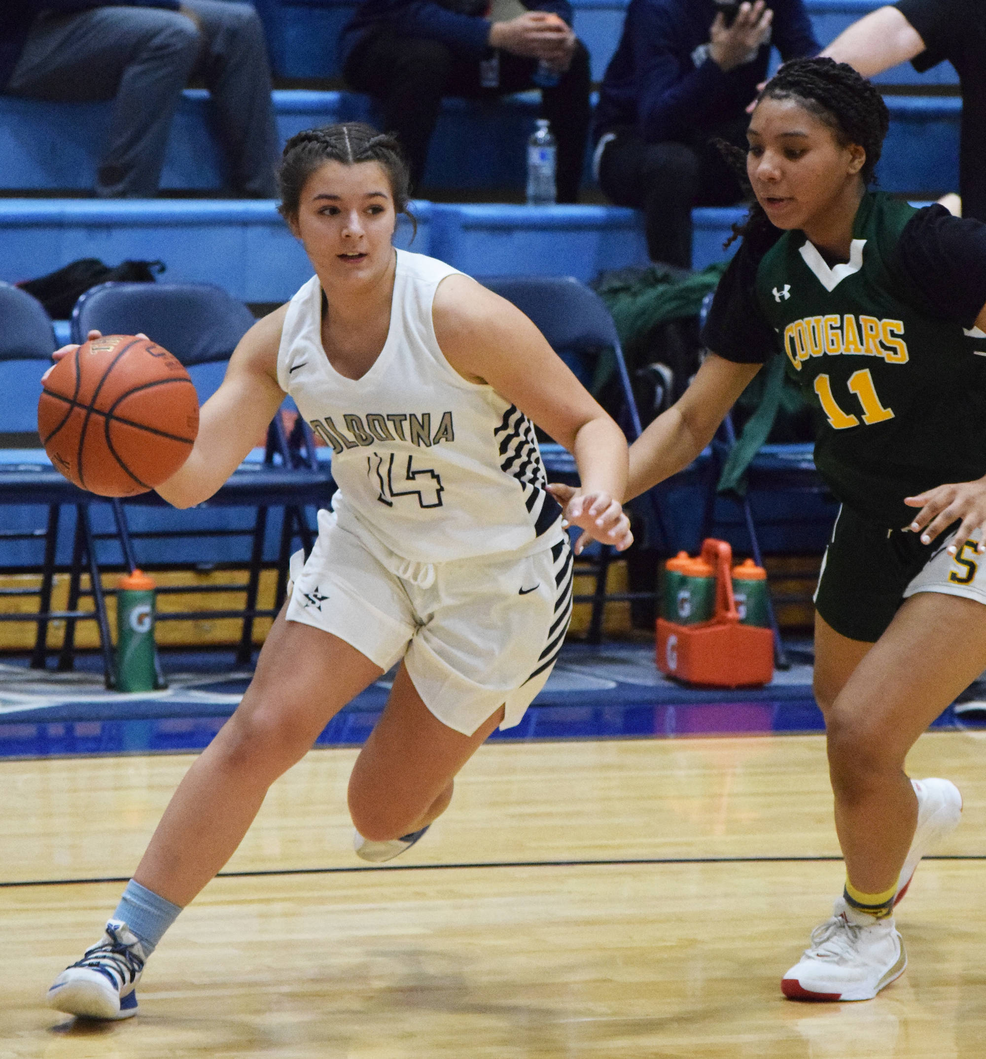 Soldotna’s Mikayla Leadens races around Service defender Neolani Quitugua-Banks, Friday, Dec. 20, 2019, at the Powerade/Al Howard Tip-Off tournament at Soldotna High School. (Photo by Joey Klecka/Peninsula Clarion)