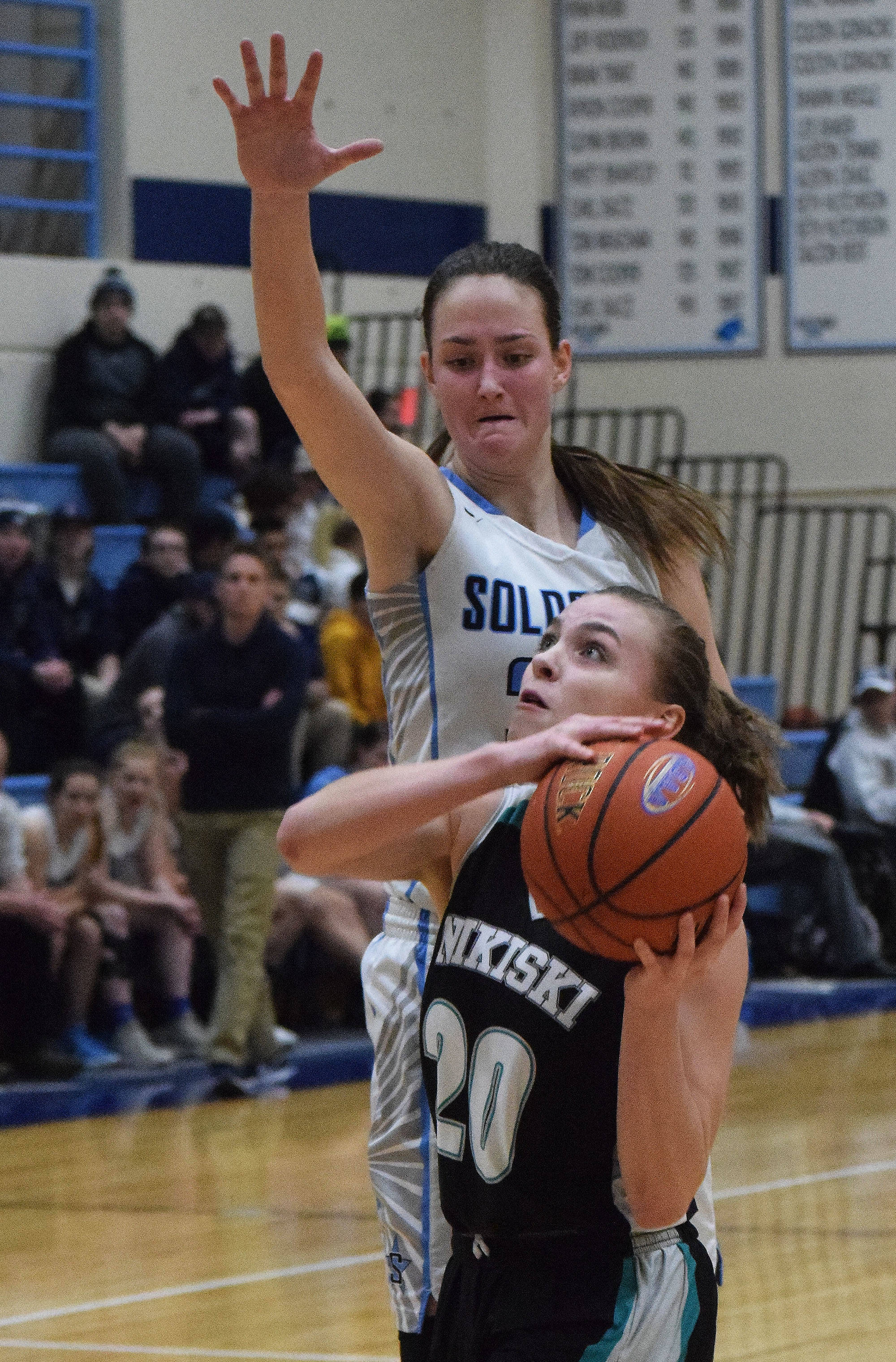 Soldotna’s Danica Schmidt (top) puts up a block on Nikiski’s Bethany Carstens Tuesday night in a nonconference game at Soldotna High School. (Photo by Joey Klecka/Peninsula Carion)