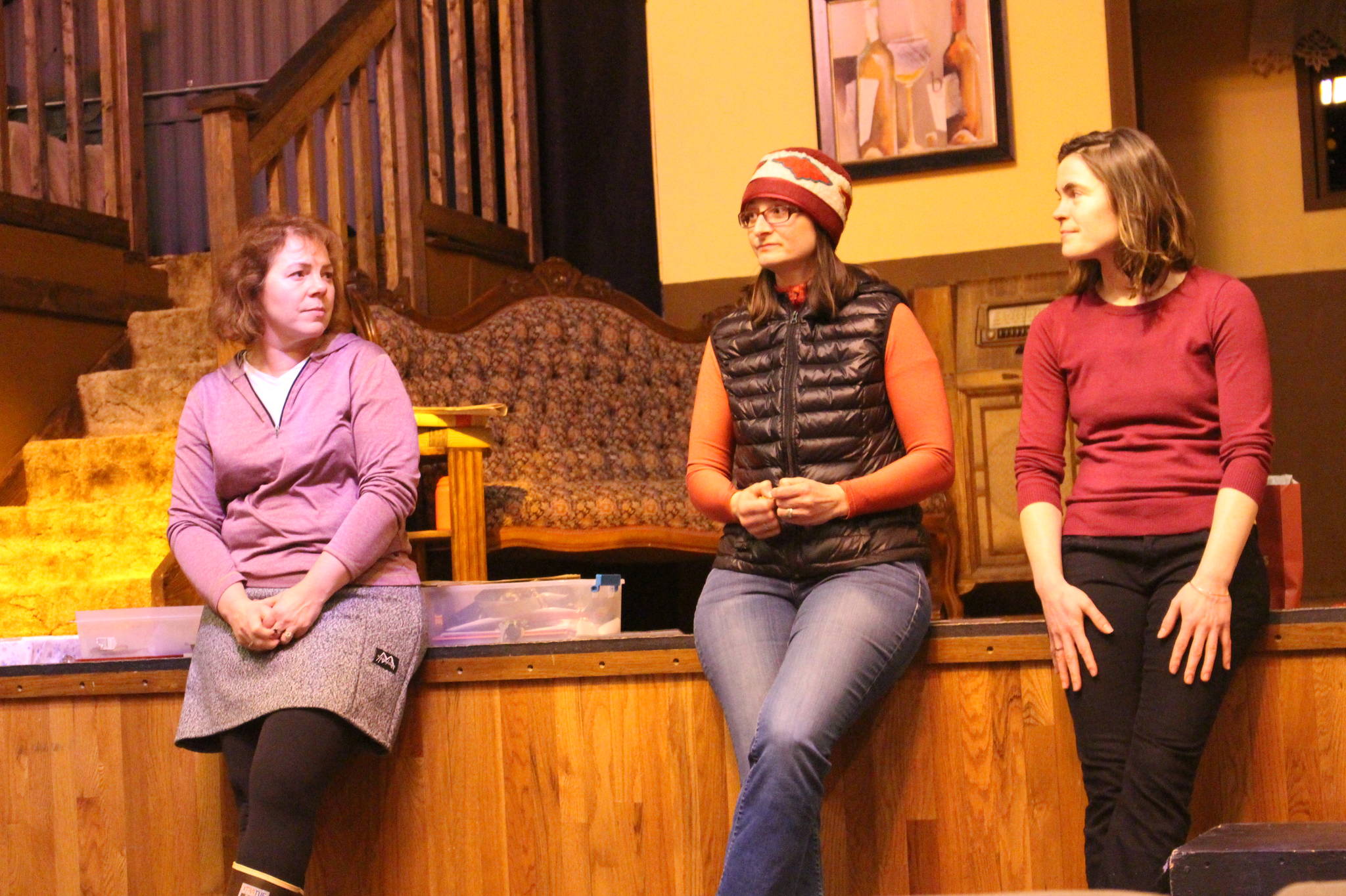From left, Wendy Dutcher, Sarah Pyhala and Kaitlin Vadla speak to members of 100+ Women Who Care at the Triumvirate Theatre in Nikiski, Alaska on Dec. 26, 2019. (Photo by Brian Mazurek/Peninsula Clarion)