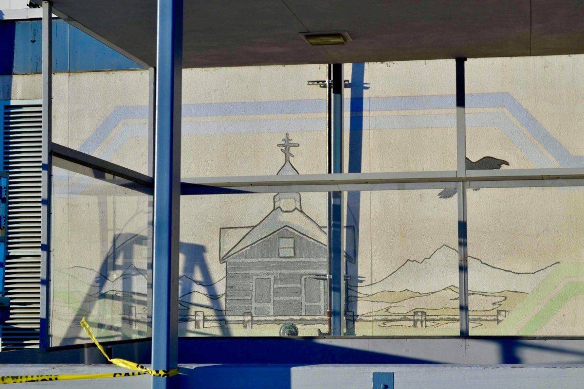 After construction workers removed siding from the facade of the Kenai Municipal Airport, a mural with iconic Kenai images like fishing nets, the St. Nicholas Russian Orthodox chapel and a dog musher, was revealed on Tuesday, Jan. 15, 2019 in Kenai, Alaska.(Photo by Victoria Petersen/Peninsula Clarion)