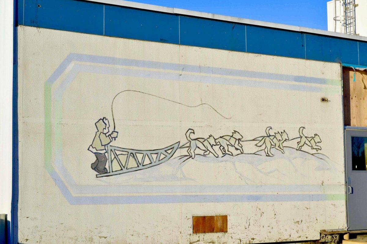 After construction workers removed siding from the facade of the Kenai Municipal Airport, a mural with iconic Kenai images like fishing nets, the St. Nicholas Russian Orthodox chapel and a dog musher, was revealed on Tuesday, Jan. 15, 2019 in Kenai, Alaska.(Photo by Victoria Petersen/Peninsula Clarion)