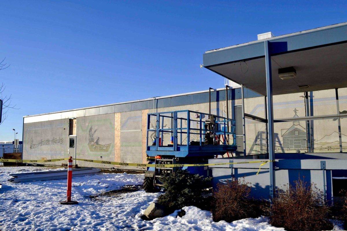 After construction workers removed siding from the facade of the Kenai Municipal Airport, a mural with iconic Kenai images like fishing nets, the St. Nicholas Russian Orthodox chapel and a dog musher, was revealed on Tuesday, Jan. 15, 2019 in Kenai, Alaska.(Photo by Victoria Petersen/Peninsula Clarion)