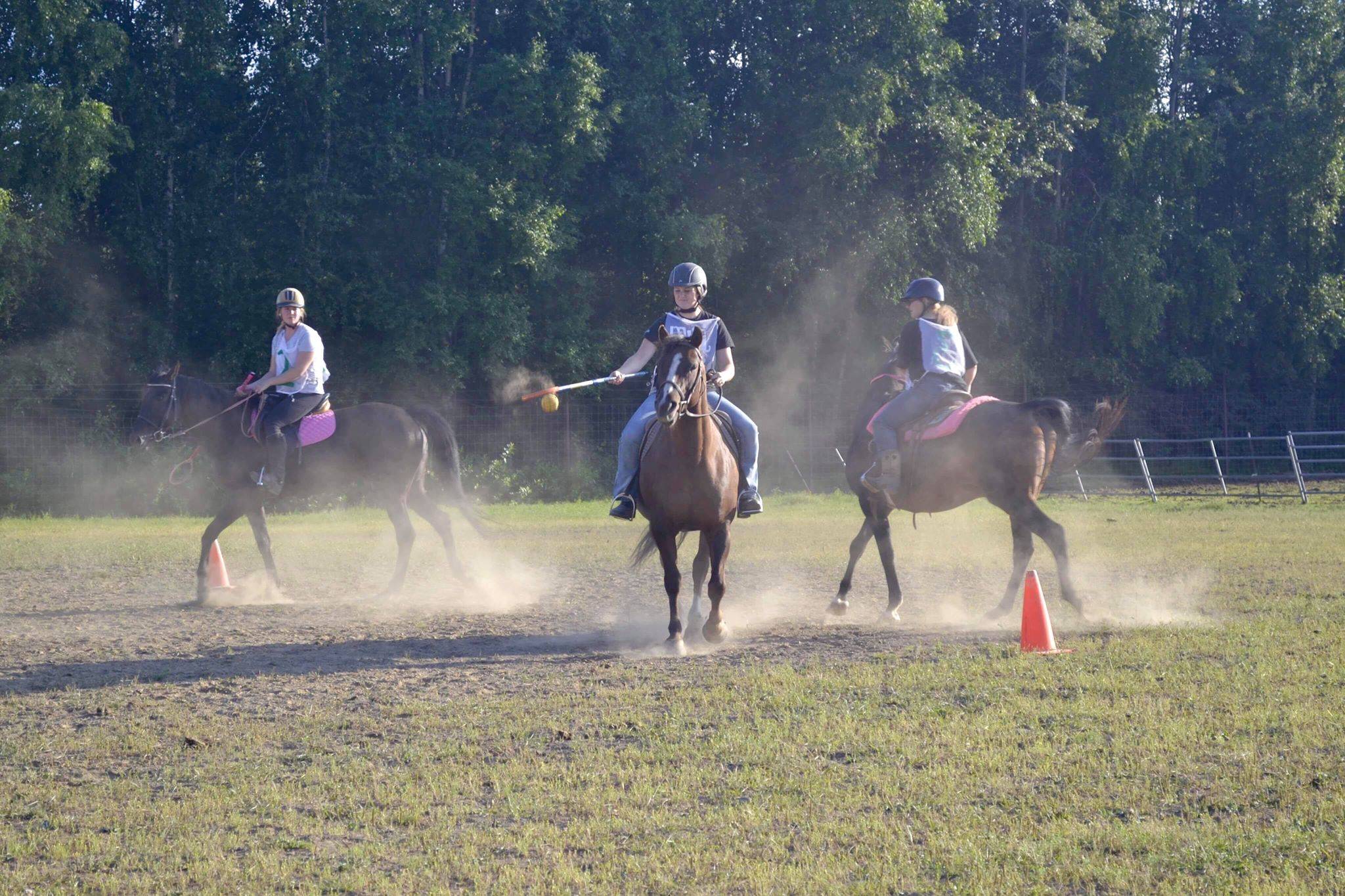 A group of riders engage in a game of polocrosse, a sport combining rules of polo and lacrosse, Thursday, July, 25, 2019 near Soldotna, Alaska. (Photo by Victoria Petersen/Peninsula Clarion)