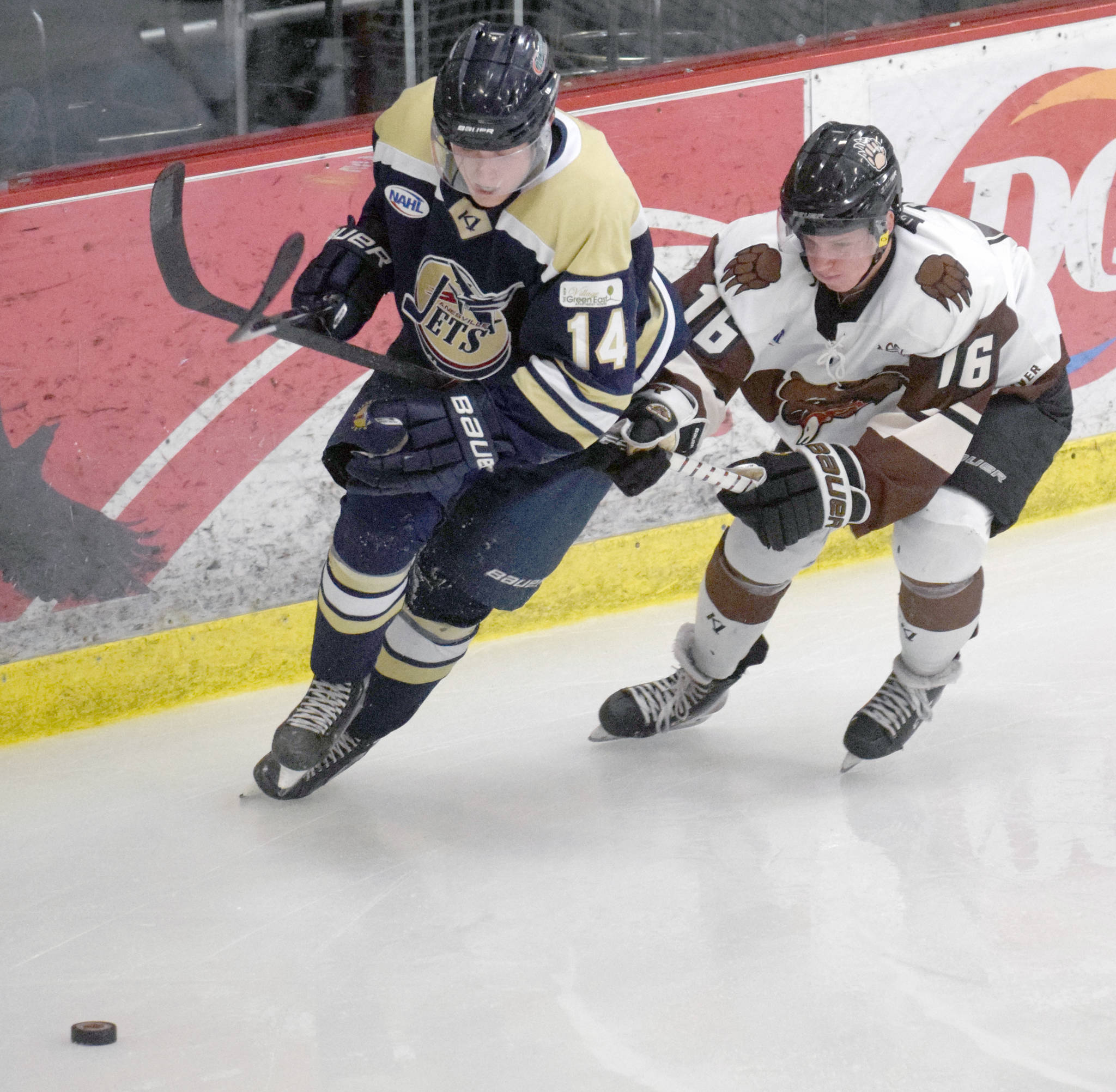 Kenai River Brown Bears forward Theo Thrun and Janesville (Wisconsin) Jets defenseman Ivar Sjolund battle for the puck Friday, Dec. 6, 2019, at the Soldotna Regional Sports Complex in Soldotna, Alaska. (Photo by Jeff Helminiak/Peninsula Clarion)