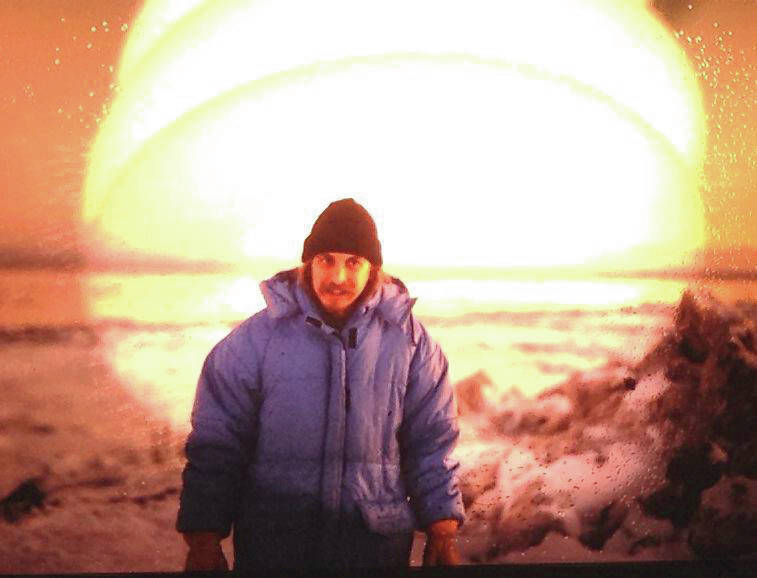 Michael Armstrong stands by Knik Arm in Anchorage shortly after arriving in Alaska in December 1979. The weird glow is caused by taking a photo of a slide illuminated by a desk lamp. (Photo provided by Mark Heffernan)