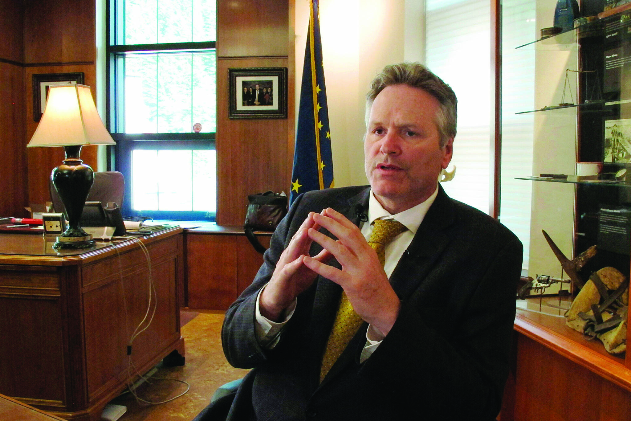 In this May 29, 2019 file photo, Alaska Gov. Mike Dunleavy speaks to reporters in his office at the state Capitol in Juneau, Alaska. (AP Photo/Becky Bohrer, File)