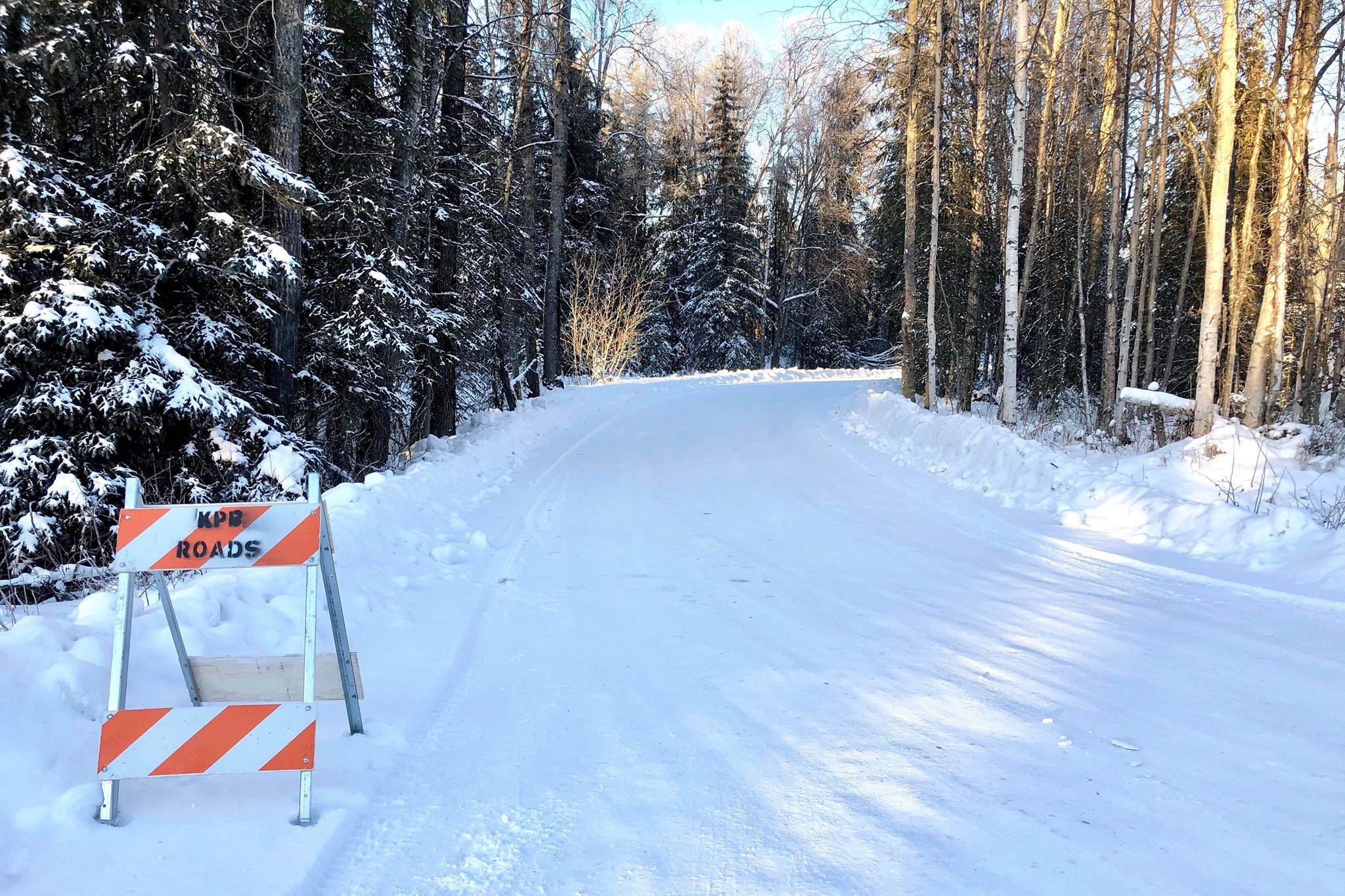 A Kenai Peninsula Borough barricade sits near Eddy Lane off of Big Eddy Road to keep traffic from traveling over flooded areas, Tuesday, Jan. 7, 2020, near Soldotna, Alaska. (Photo by Victoria Petersen/Peninsula Clarion)