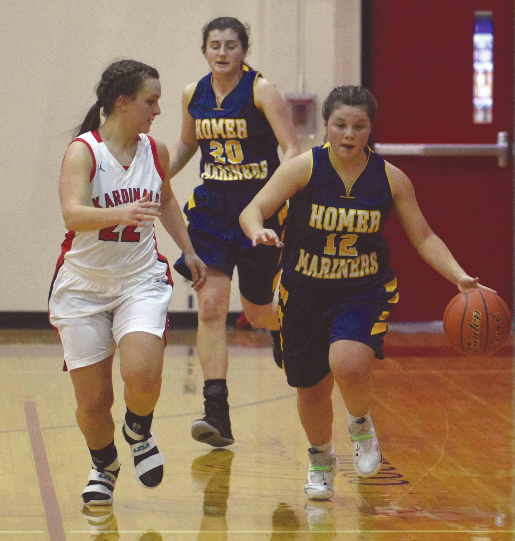 Homer’s Rylee Doughty dribbles against Kenai Central’s Jaiden Streiff on Friday, Jan. 10, 2019, at Kenai Central High School in Kenai, Alaska. (Photo by Jeff Helminiak/Peninsula Clarion)