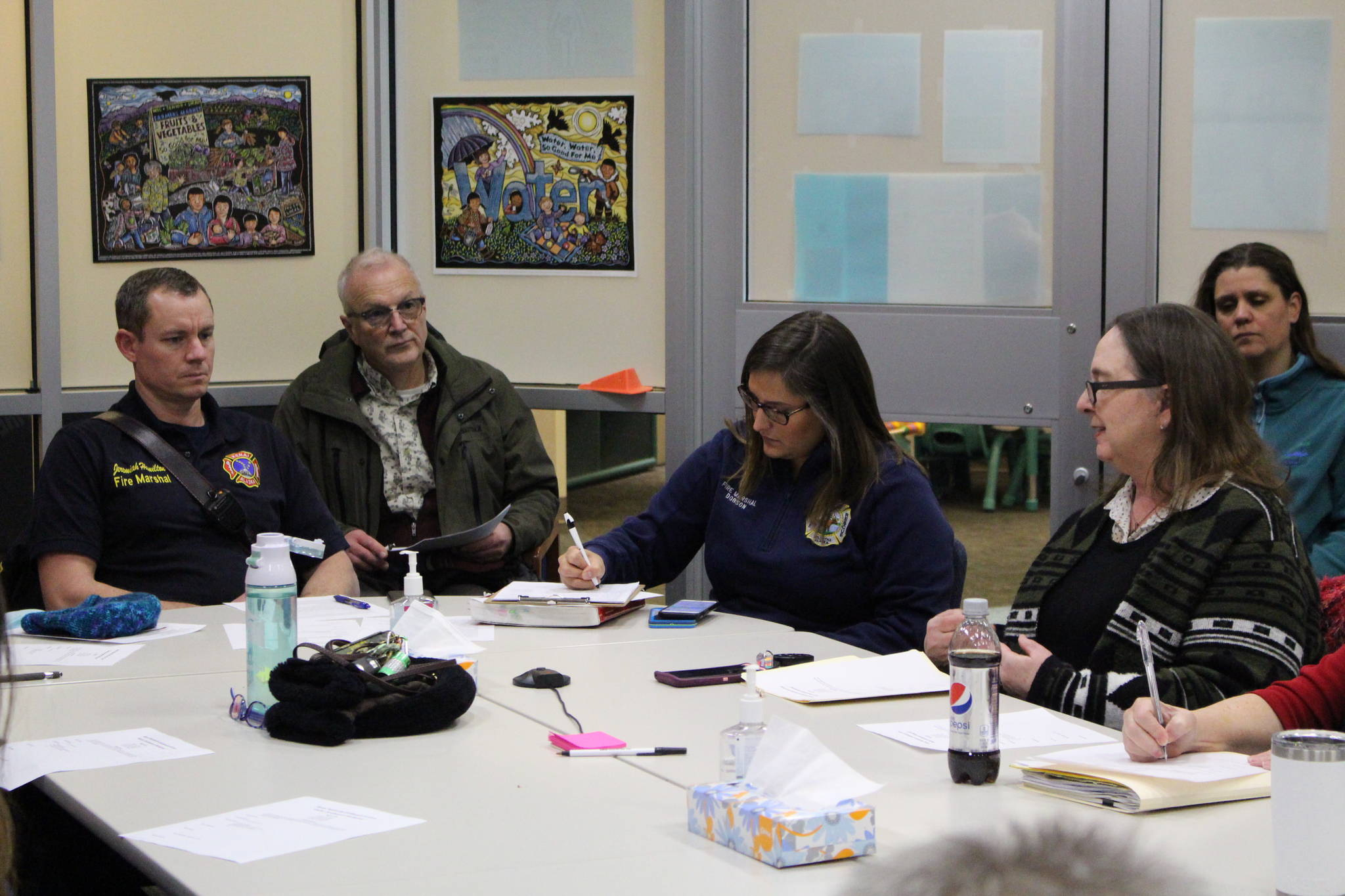 Fire Marshals Jeremy Hamilton, left, and Brooke Dobson, center right, meet with members of the Shelter Development Workgroup at the Kenai Public Health Center in Kenai, Alaska on Jan. 8, 2020. (Photo by Brian Mazurek/Peninsula Clarion)