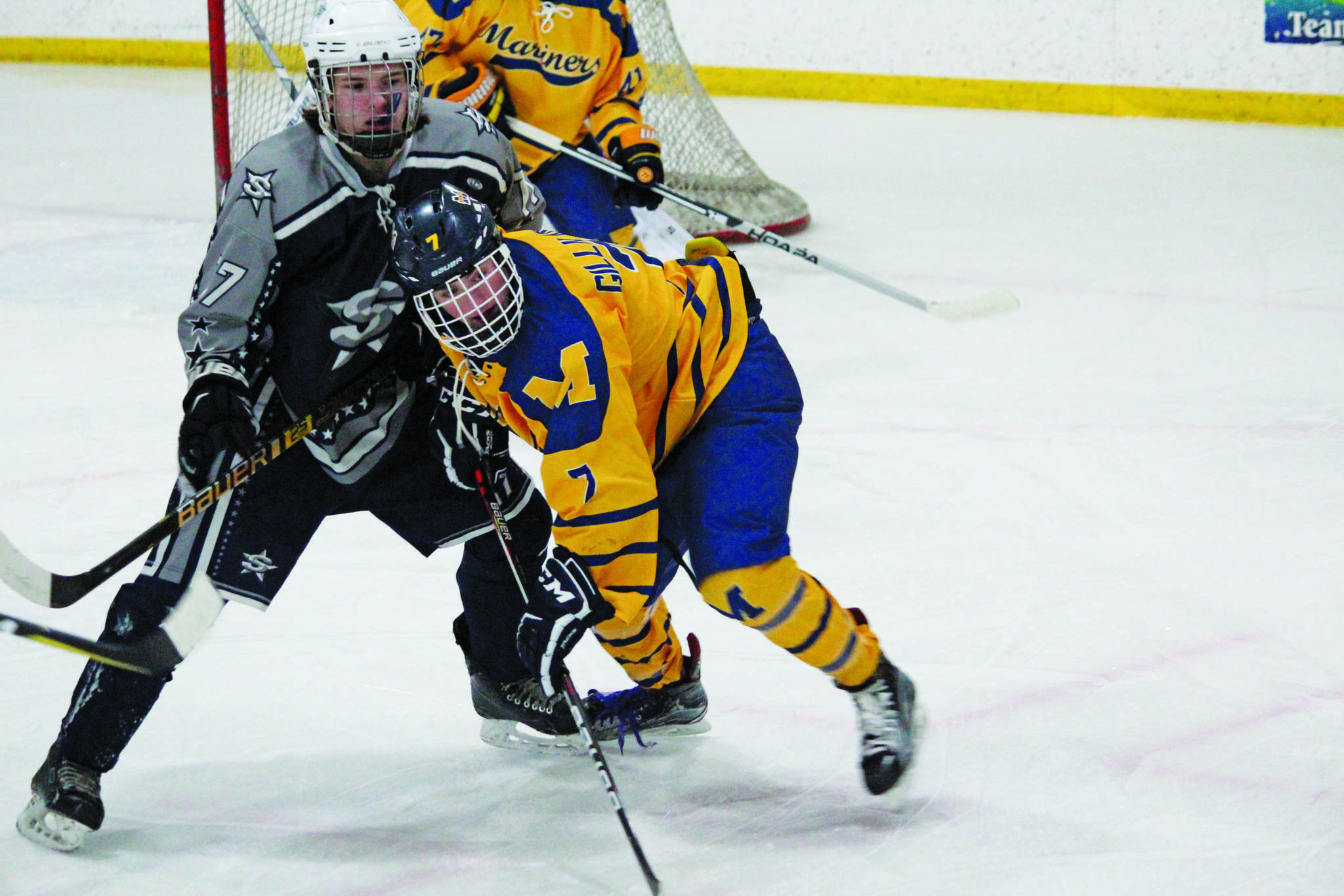 Homer’s Tyler Gilliland and Soldotna’s Wyatt Medcoff jockey for position during a Wednesday, Jan. 15, 2020 hockey game at Kevin Bell Arena in Homer, Alaska. (Photo by Megan Pacer/Homer News)