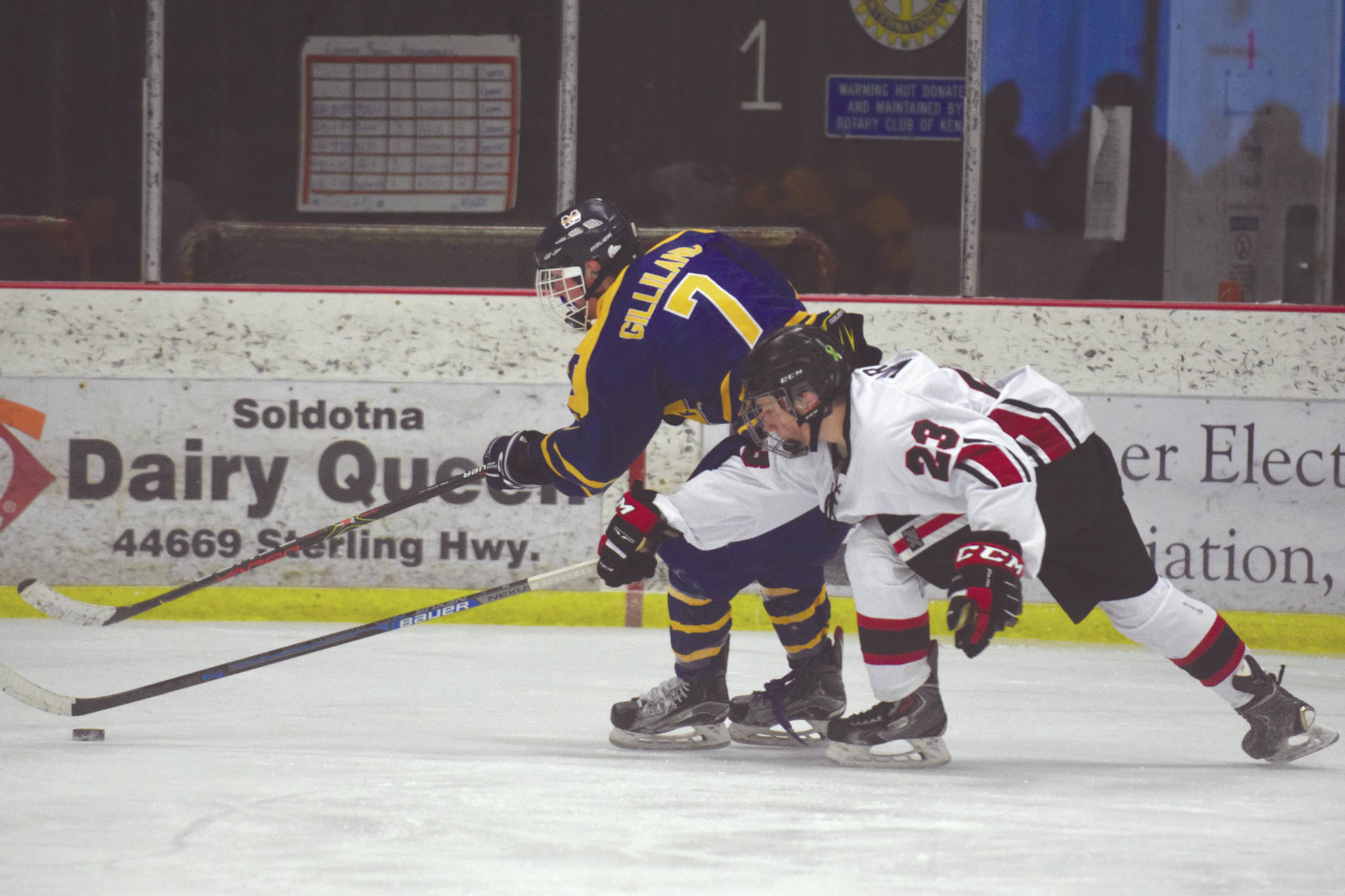 Homer’s Tyler Gilliland tries to keep the puck from Kenai Central’s Caden Warren on Saturday, Jan. 18, 2020, at the Kenai Multi-Purpose Facility in Kenai, Alaska. (Photo by Jeff Helminiak/Peninsula Clarion)