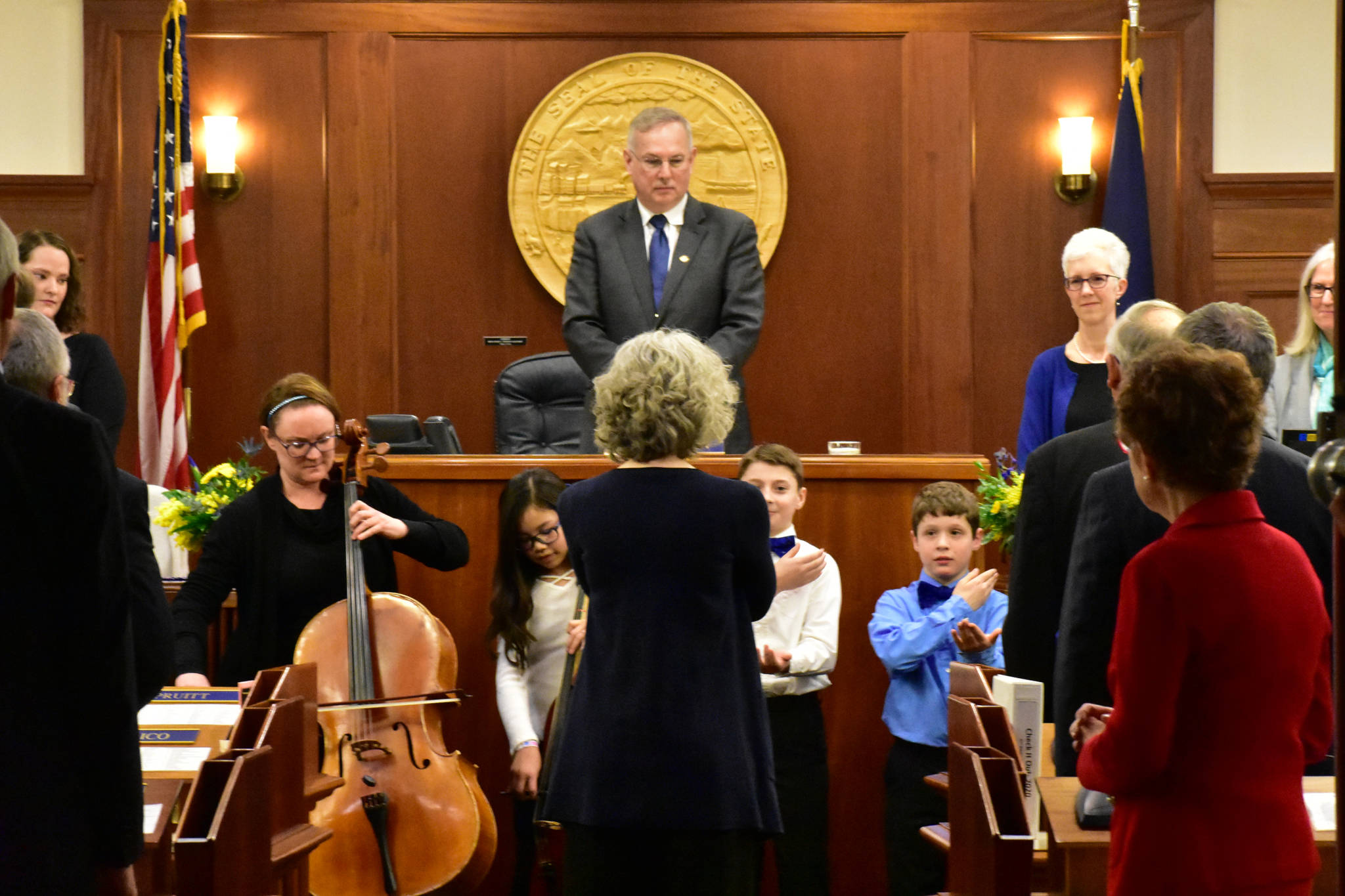 House Speaker Bryce Edgmon, I-Dillingham, looks on as Juneau Alaska Music Matters students from Glacier Valley School and singers from Sayéik: Gastineau Community School perform “Alaska’s Flag” on Tuesday.(Peter Segall | Juneau Empire)