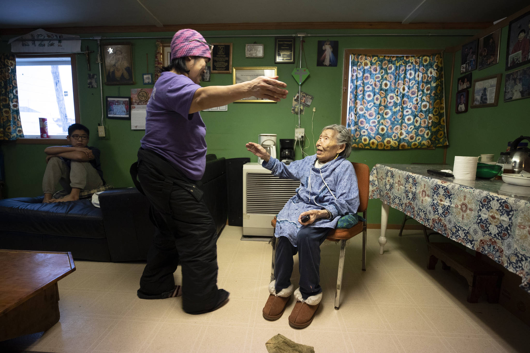 In this Monday, Jan. 20, 2020 image, Lizzie Chimiugak, right, gets a hug from her granddaughter Janet Lawrence at her home in Toksook Bay, Alaska. Chimiugak, who turned 90 years old on Monday, is scheduled to be the first person counted in the 2020 U.S. Census on Tuesday. (AP Photo/Gregory Bull)