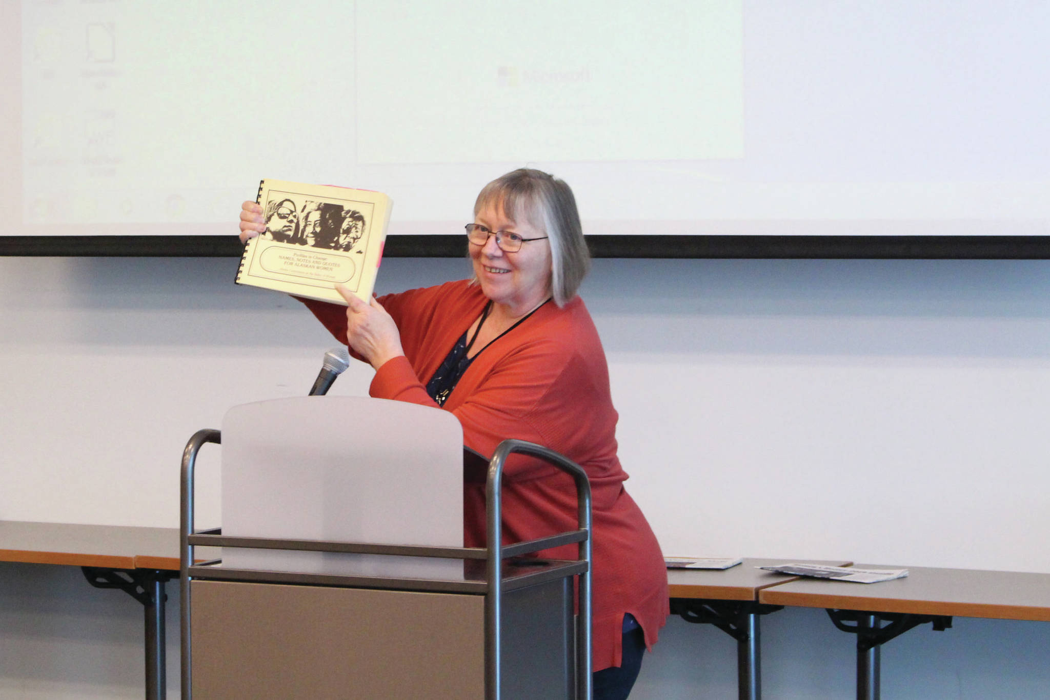 Brian Mazurek / Peninsula Clarion                                Barbara Waters holds up the book “Profiles in Change: Names, Notes, and Quotes for Alaskan Women” by Ginna Brelsford while discussing women’s history in Alaska during the Centennial Voices event at the Soldotna Public Library in Soldotna on Saturday.