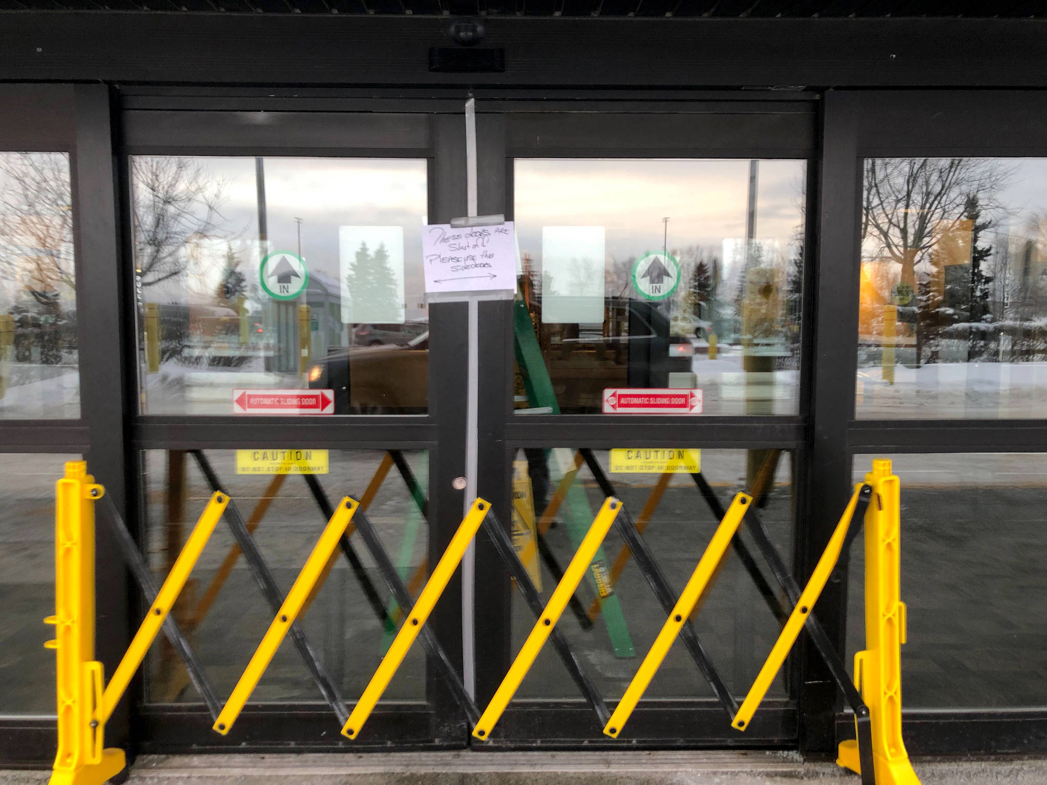 A closed entrance at the north terminal at Ted Stevens Anchorage International Airport in Anchorage, where a flight plane carrying U.S. citizens being evacuated from Wuhan, China is expected later Tuesday, is seen Tuesday. (AP Photo/Mark Thiessen)