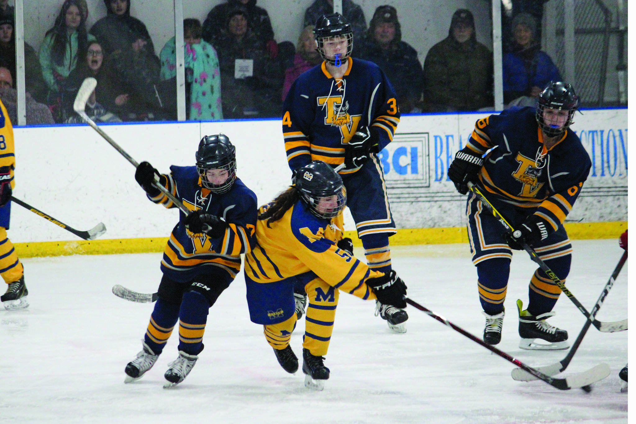 Homer’s Haylee Owen tries to maintain control of the puck under pressure from Tri-Valley School’s Will Tomeo during a Thursday, Jan. 30, 2020 hockey game at Kevin Bell Arena in Homer, Alaska. (Photo by Megan Pacer/Homer News)