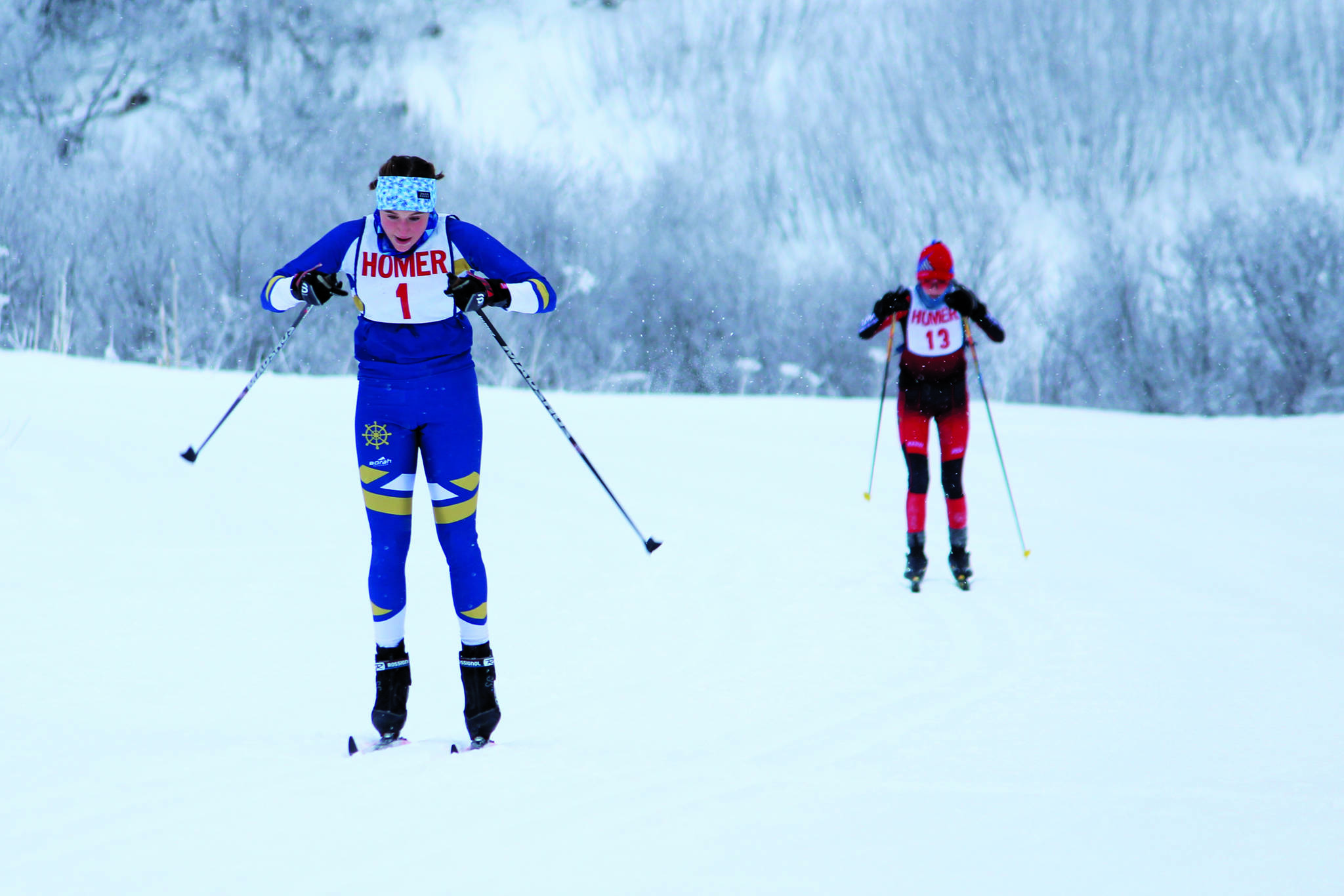 Homer’s Autumn Daigle skis to the finish of a Friday, Jan. 31, 2020 classic ski race ahead of Kenai’s Jayna Boonstra during the Homer Invite at the Lookout Mountain Trails on Ohlson Mountain Road near Homer, Alaska. (Photo by Megan Pacer/Homer News)