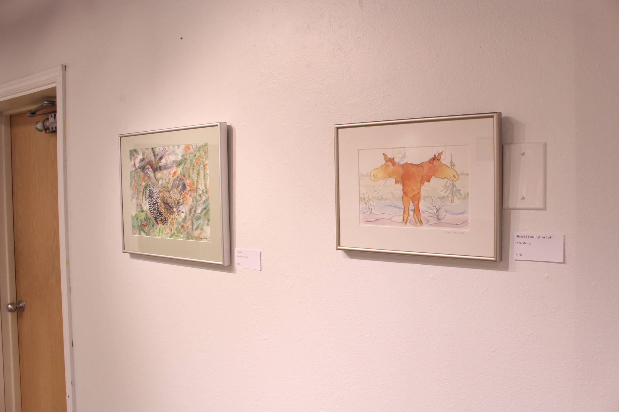 Watercolor paintings by Carolyn Snowder and Ann Mercer are seen on display at the Kenai Fine Art Center in Kenai, Alaska on Feb. 4, 2020. (Photo by Brian Mazurek/Peninsula Clarion)