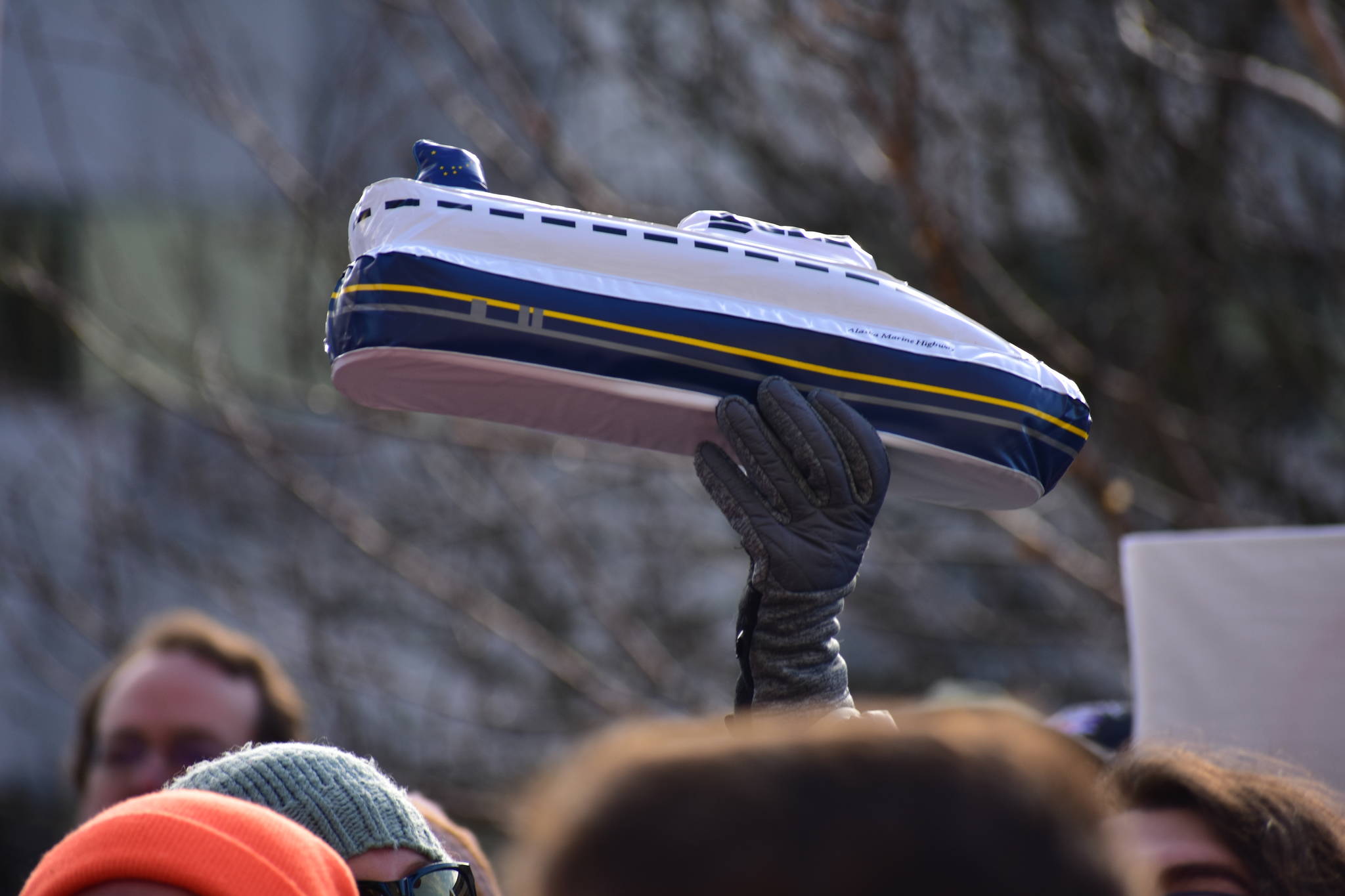 Someone holds up an inflatable Alaska Marine Highway ferry at at a rally to support of the Alaska Marine Highway System on Tuesday, Feb. 11, 2020. (Peter Segall | Juneau Empire)