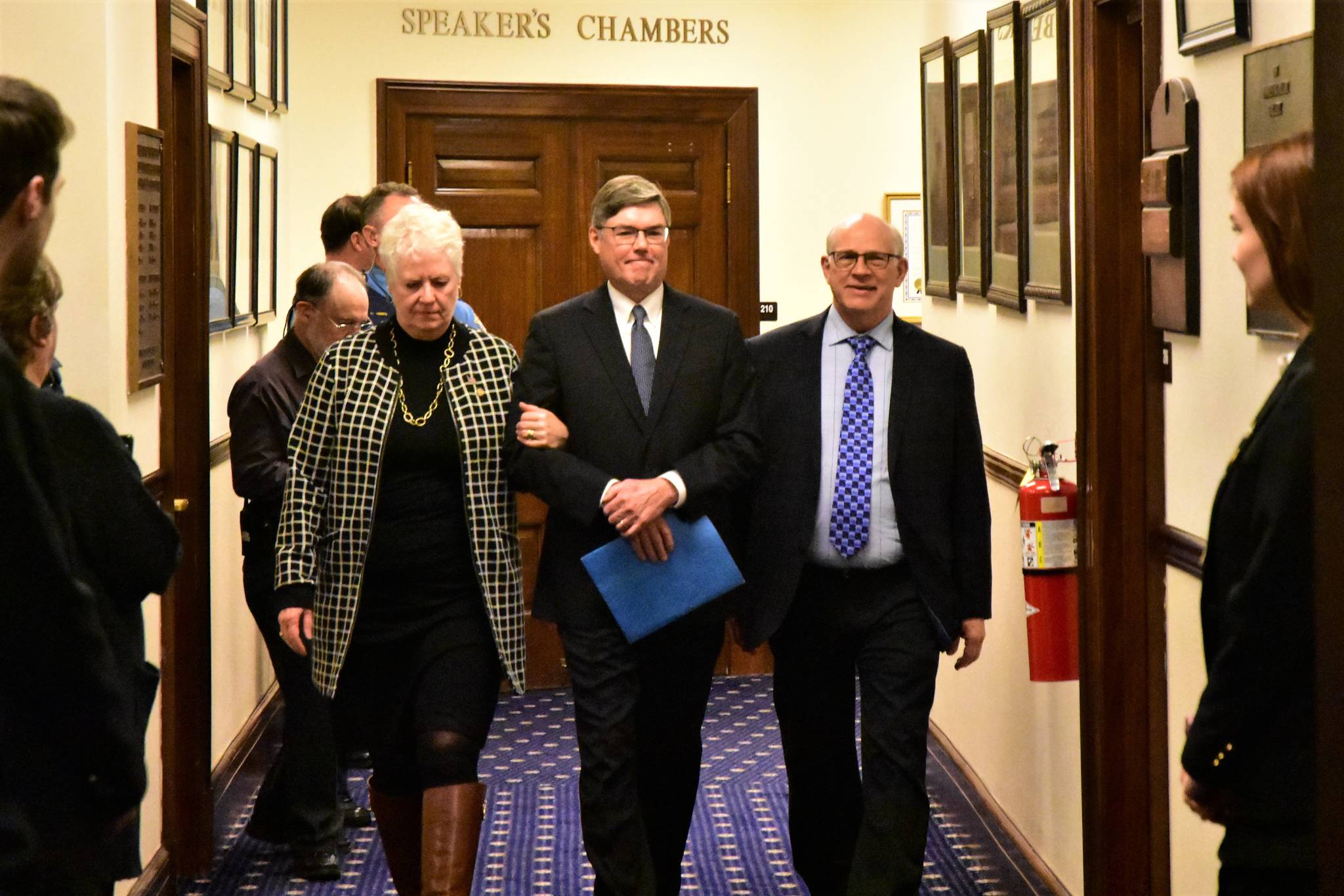 Peter Segall | Juneau Empire                                Alaska Supreme Court Chief Justice Joel M. Bolger, center, is escorted into the House Chamber by Rep. Louise Stutes, R-Kodiak, and Sen. John Coghill, R-North Pole, on Wednesday.