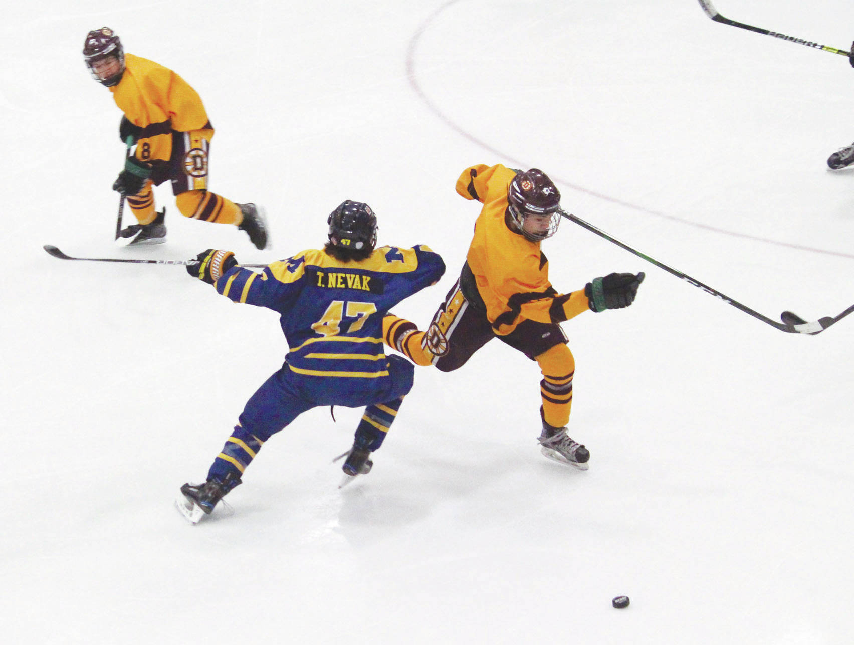 Dimond’s Tyler Christiansen skates around Homer’s Toby Nevak during a Friday, Feb. 14, 2020 game at the 2020 ASAA First National Cup Division I Hockey State Championship at the Curtis D. Menard Memorial Sports Center in Wasilla, Alaska. (Photo by Megan Pacer/Homer News)