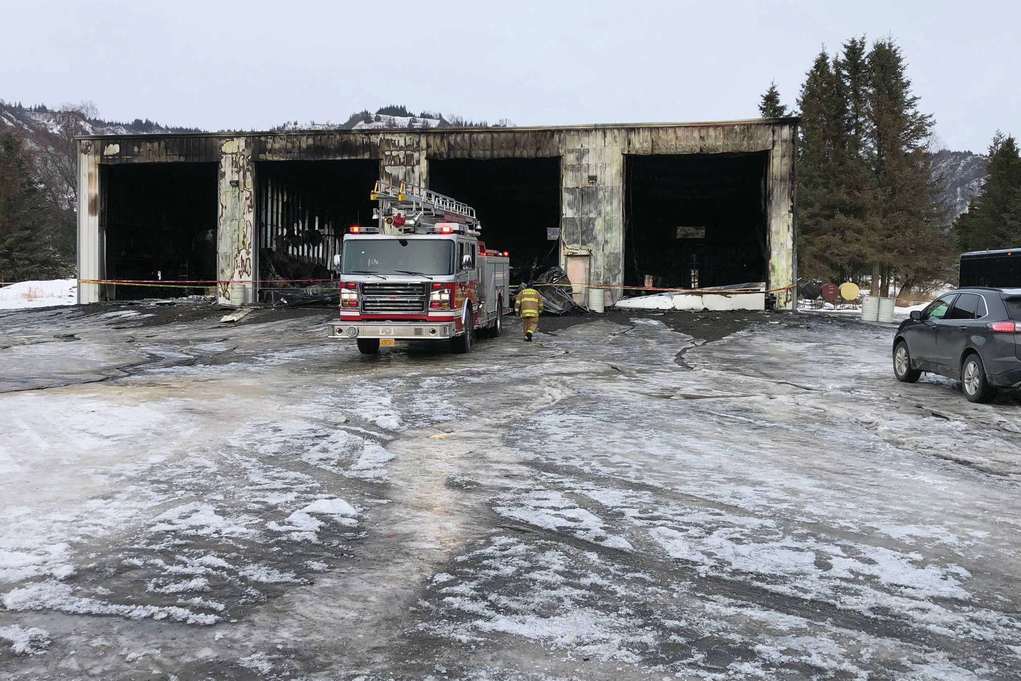 Kachemak Emergency Services firefighters on Friday afternoon, Feb. 14, 2020, clean up a structure fire on Kent Street near Mile 6.5 East End Road east of Homer, Alaska. A fire in a boat shop that started about 3:25 a.m. Feb. 14 totally destroyed the building. (Photo courtesy Kachemak Emergency Services)