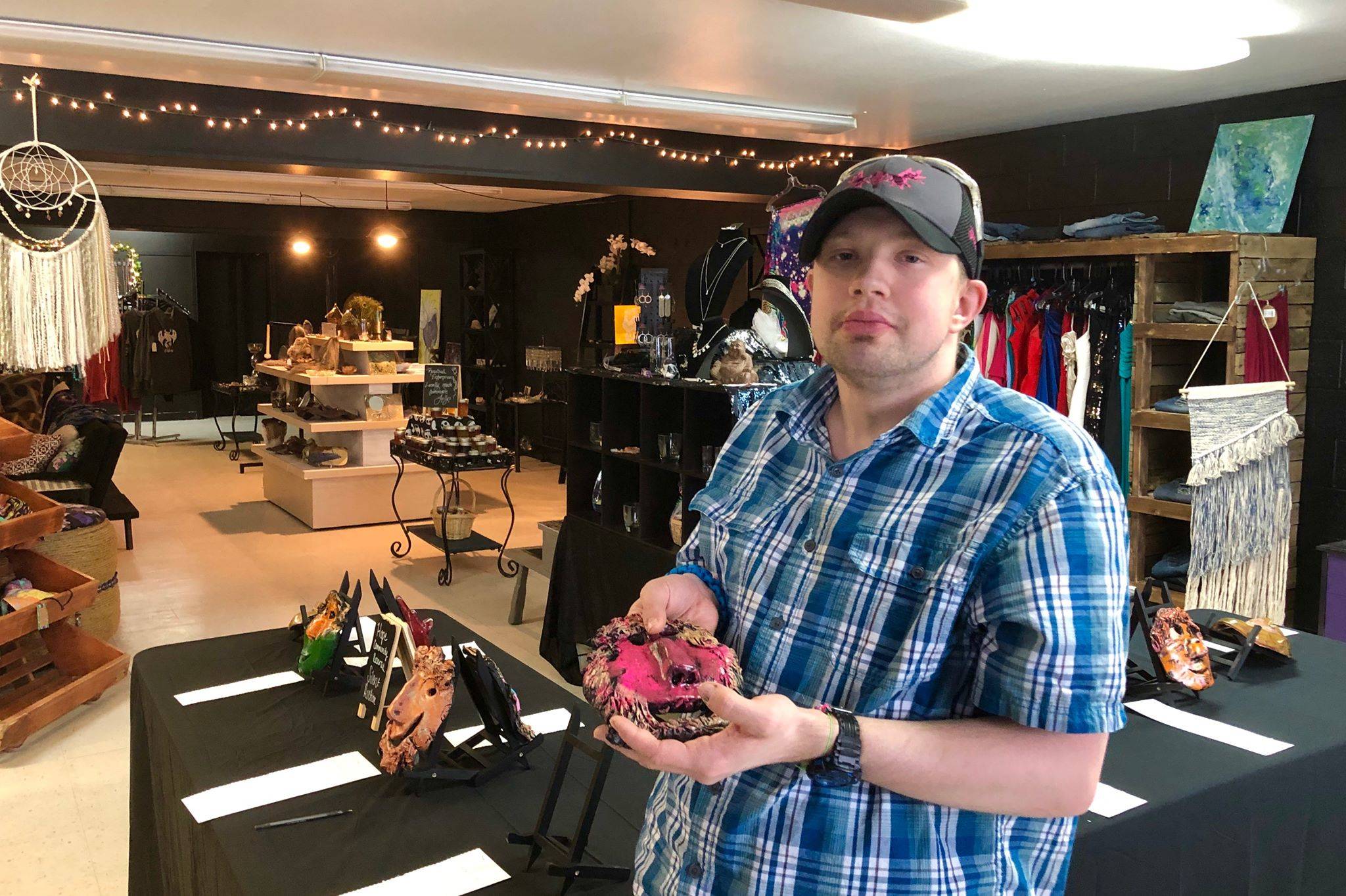 Ethan Satterwhite showcases a clay mask he created in an art class at Hope Community Resources Feb. 18, 2020, in Soldotna, Alaska. (Photo by Victoria Petersen/Peninsula Clarion)