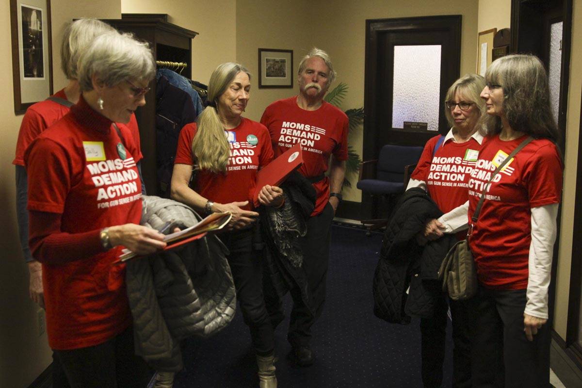 Members of Moms Demad Action for Gun Sense in America discuss assignments before soliciting lawmakers for their support of House Bill 62, or the ability to temporarily take guns away from people who have made threats or are having a mental health crisis. (Michael S. Lockett | Juneau Empire)