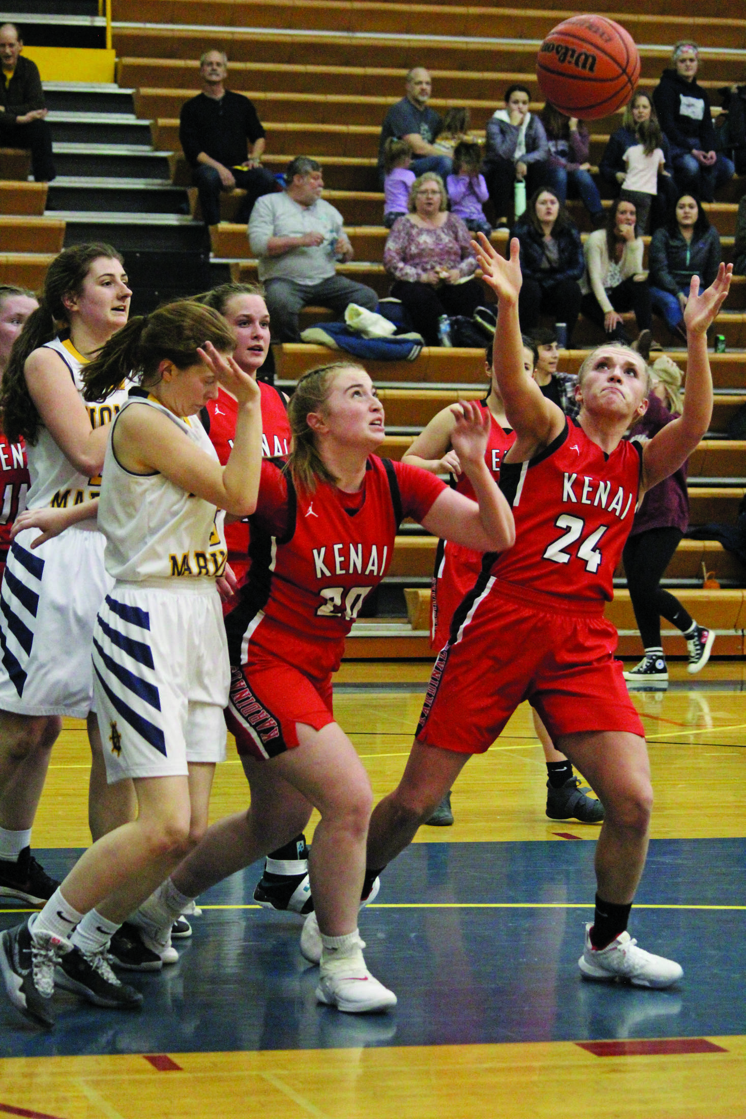 Kenai’s Damaris Severson reaches for the ball after it comes loose during a Wednesday, Feb. 19, 2020 basketball game at Homer High School in Homer, Alaska. (Photo by Megan Pacer/Homer News)