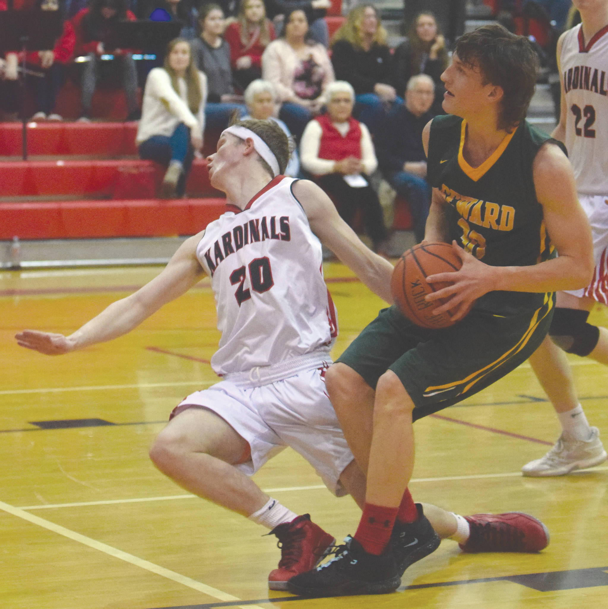 Kenai’s Andrew Bezdecny draws a charge from Seward’s Bjorn Nilsson on Friday, Feb. 28, 2020, at Kenai Central High School in Kenai, Alaska. (Photo by Jeff Helminiak/Peninsula Clarion)