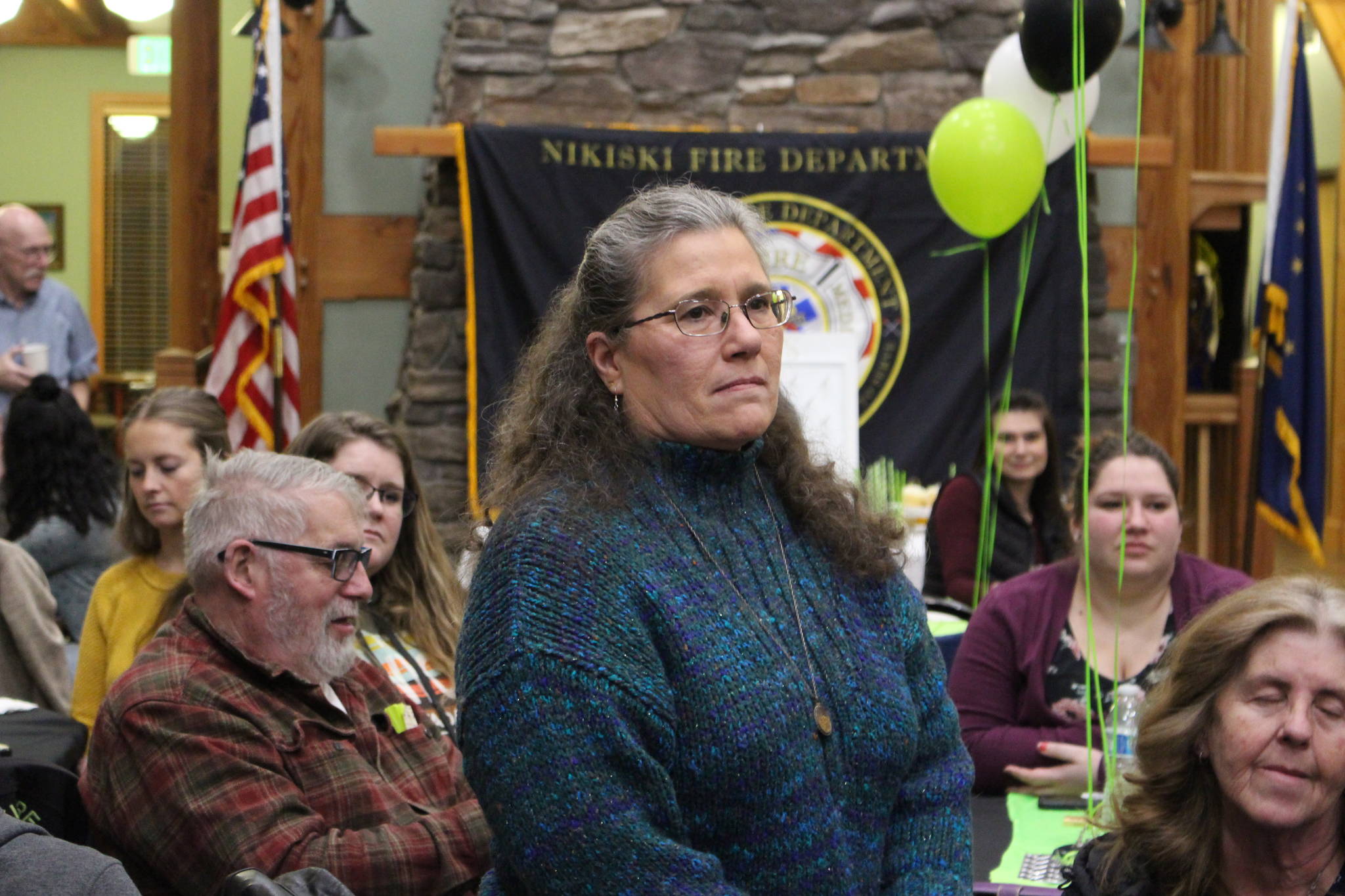 Brian Mazurek / Peninsula Clarion                                 Wildwood Correctional Officer Amy Fisher listens as the Nikiski Fire Department honors the first responders who played a part in saving her life last October during the Nikiski Fire Department’s 2019 Award Ceremony at the Nikiski Senior Center on Feb. 28.                                Wildwood Correctional Officer Amy Fisher listens as the Nikiski Fire Department honors the individuals who played a part in saving her life last October during the Nikiski Fire Department’s 2019 Award Ceremony in the Nikiski Senior Center on Feb. 28, 2020. (Photo by Brian Mazurek/Peninsula Clarion)
