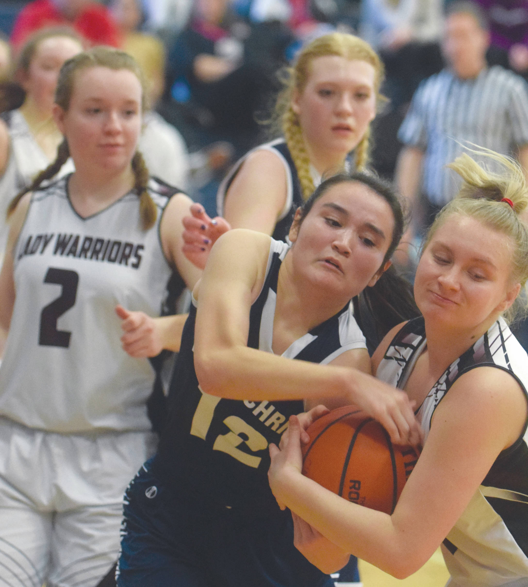 Lumen Christi’s Kaiya Thornsness and Nikolaevsk’s Kerianna Lasiter battle for the ball Thursday, March 5, 2020, at the Peninsula Conference basketball tournament at Cook Inlet Academy in Soldotna, Alaska. (Photo by Jeff Helminiak/Peninsula Clarion)