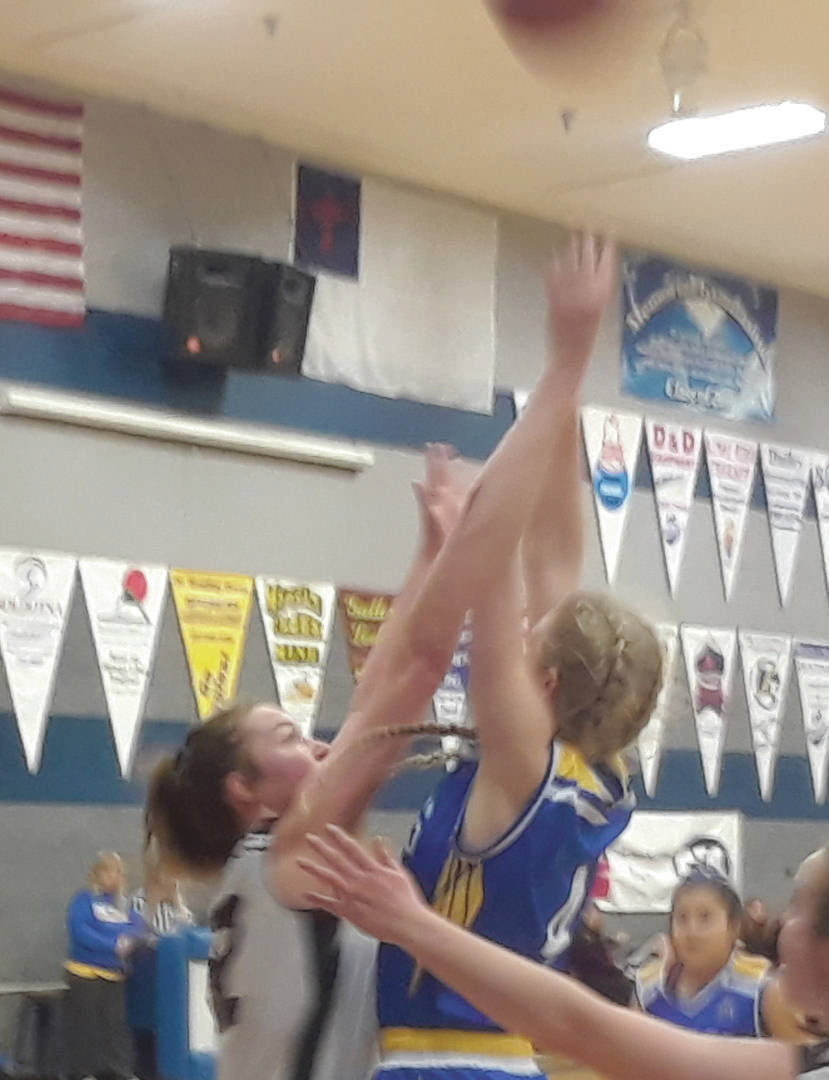 Cook Inlet Academy senior Anna Henderson goes up for a contested shot against Nikolaevsk senior Elizabeth Fefelov on Friday, March 6, 2020, in the Peninsula Conference championship game at Cook Inlet Academy in Soldotna, Alaska. (Photo by Dan Balmer/For the Clarion)
