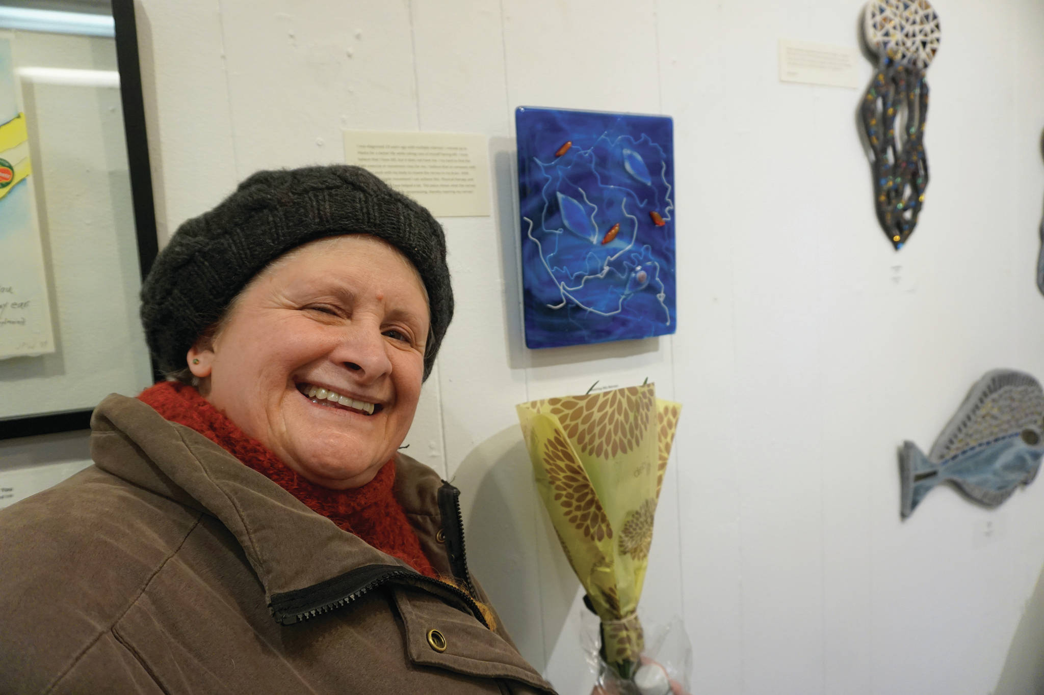 Cindy Nelson stands by her art on March 6, 2020, at the Disability Art Show at the Homer Council on the Arts in Homer, Alaska. (Photo by Michael Armstrong/Homer News)