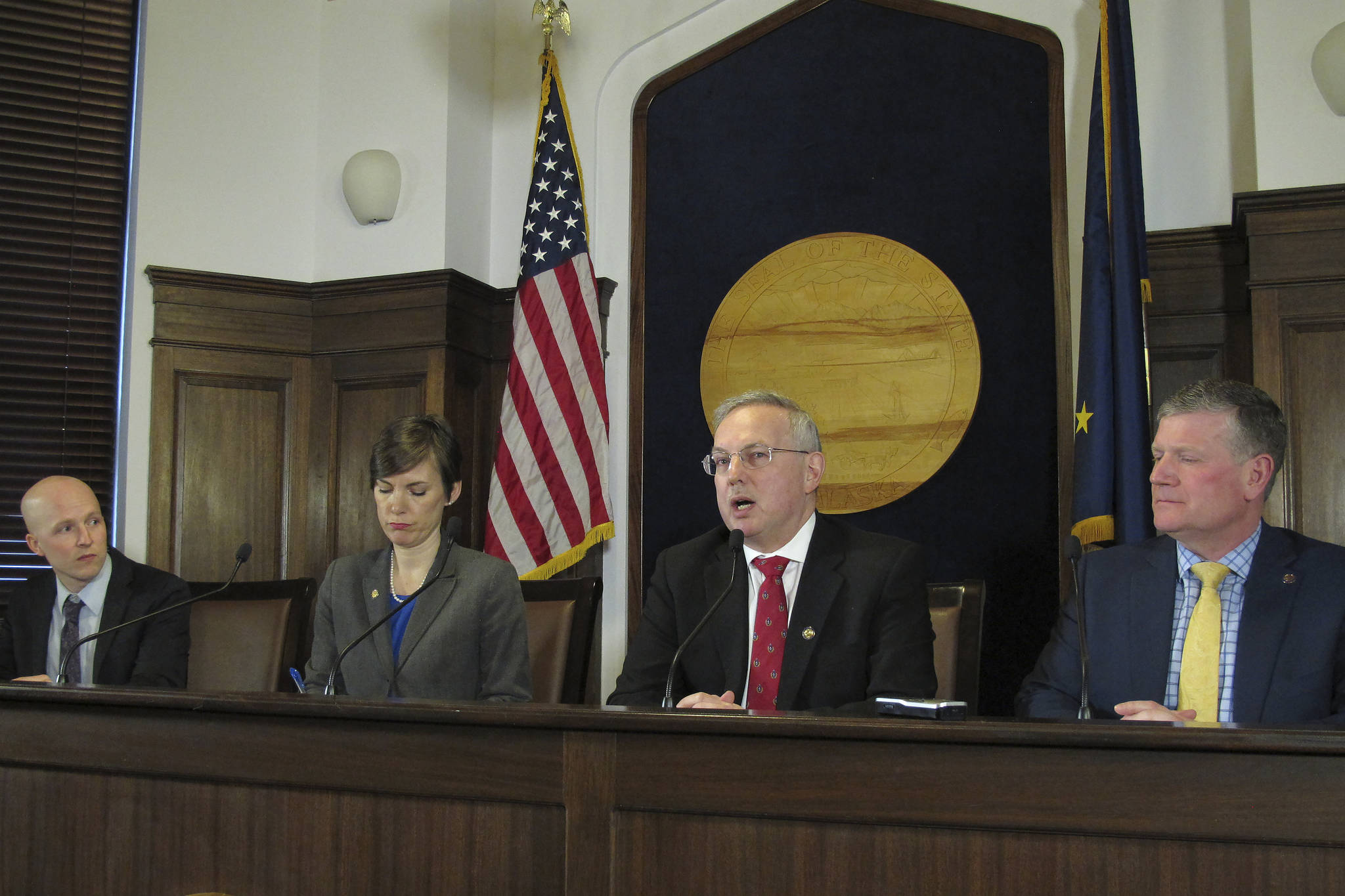 Alaska House Speaker, second from right, speaks to reporters on Monday, March 16, 2020, in Juneau, Alaska. Pictured from left are Reps. Jonathan Kreiss-Tomkins, Ivy Spohnholz, Edgmon and Chuck Kopp. (AP Photo/Becky Bohrer)