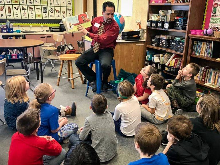 Superintendent John O’Brien reads to students at Mountain View Elementary. (Photo courtesy of the Kenai Peninsula Borough School District Communications Blog/Pegge Erkeneff)