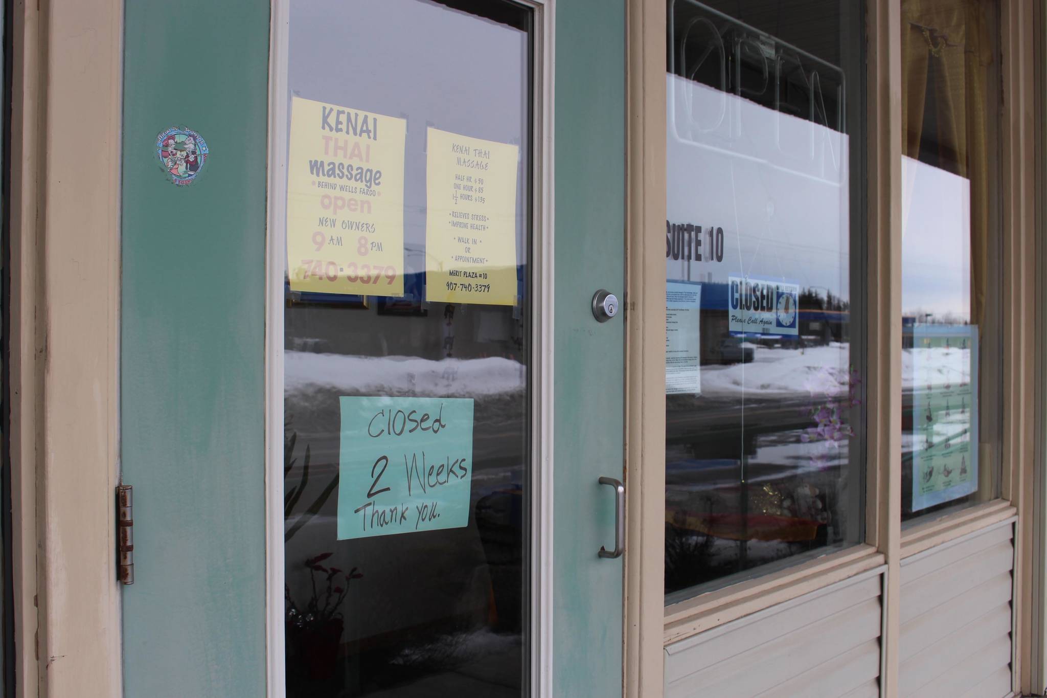 A sign outside of Kenai Thai Massage indicating that they are closed for two weeks can be seen here in Kenai, Alaska, on March 25, 2020. (Photo by Brian Mazurek/Peninsula Clarion)