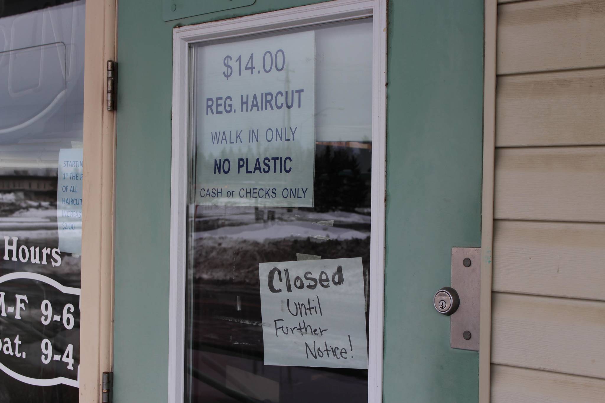 A sign outside of RD’s Barber Shop indicates that they are closed until further notice, Kenai, Alaska, on March 25, 2020. (Photo by Brian Mazurek/Peninsula Clarion)