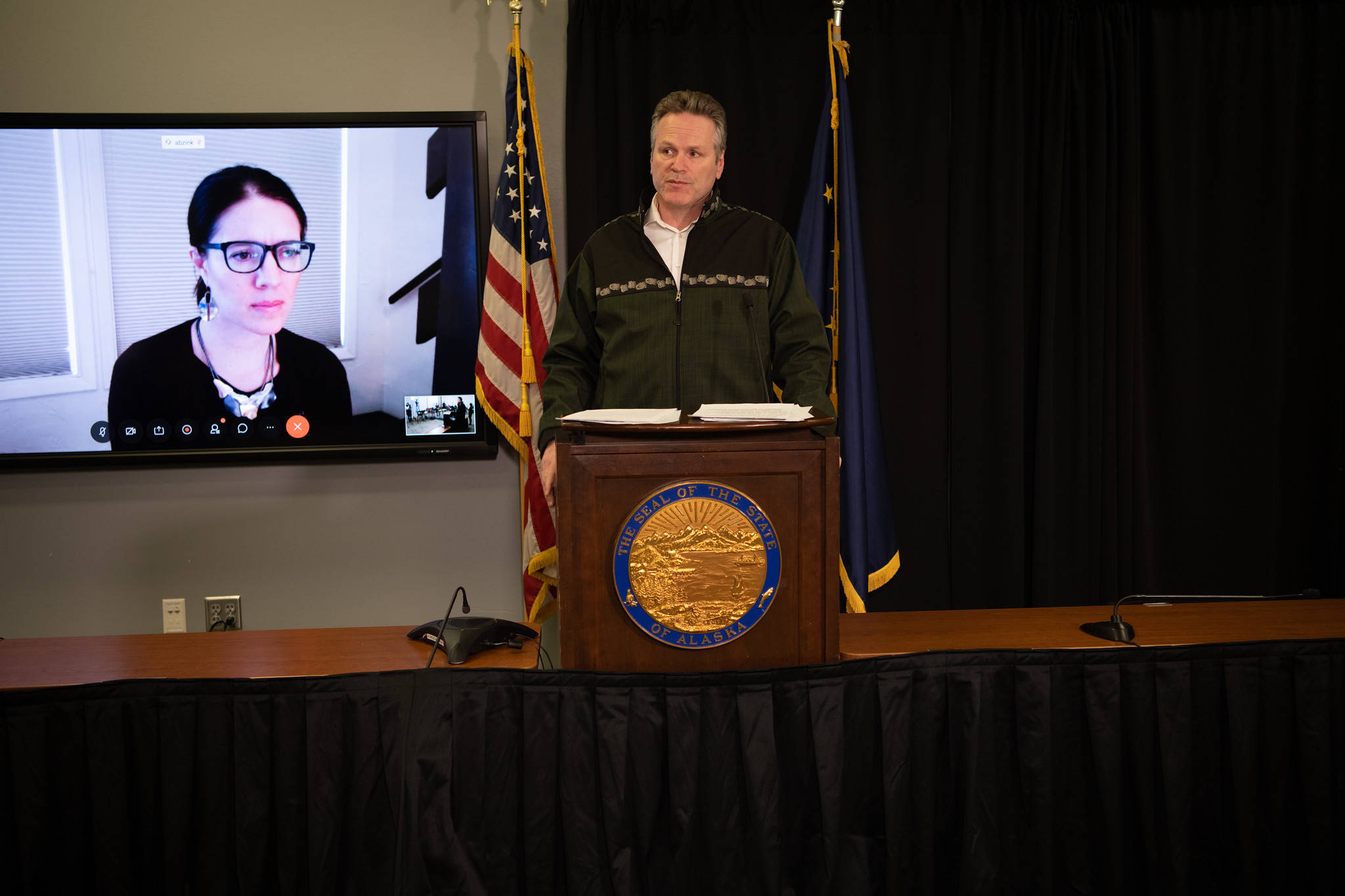 Gov. Mike Dunleavy presents with Chief Medical Officer Dr. Anne Zink via teleconference in Anchorage during March 31, 2020 coronavirus press update. (Courtesy photo)