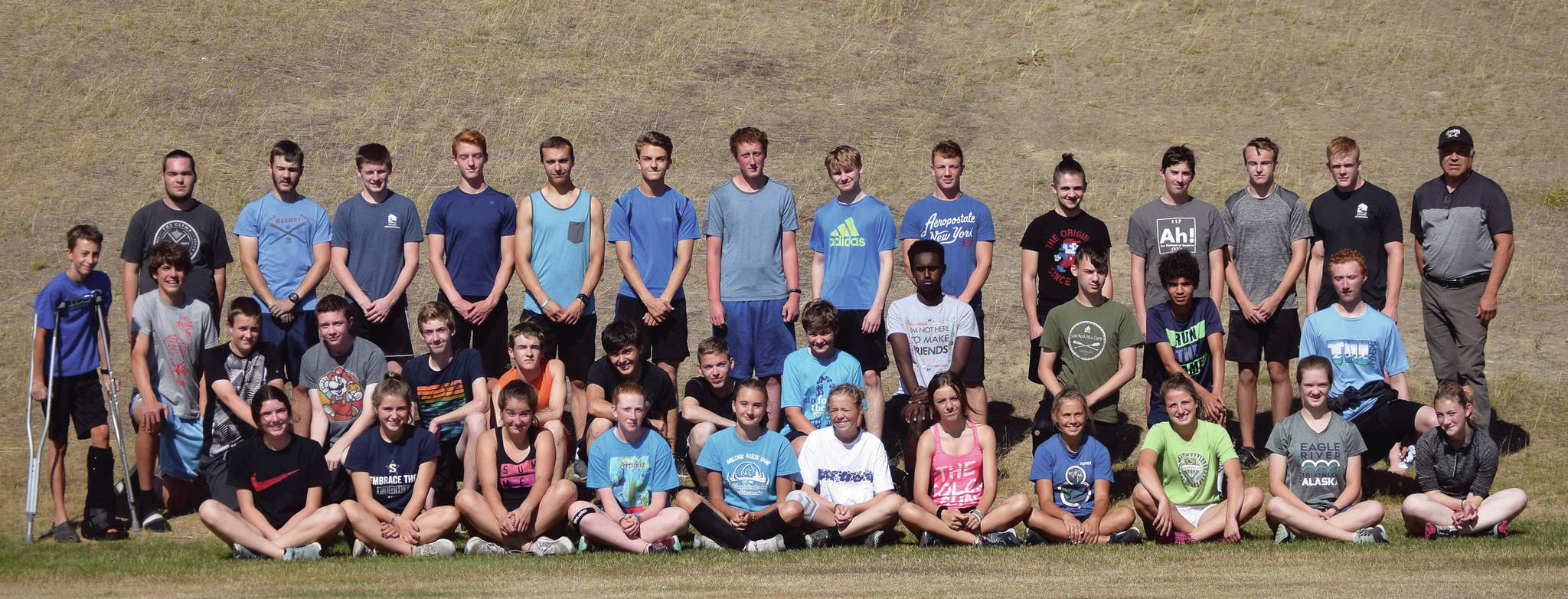 Soldotna cross-country running coach Ted McKenney, standing and far right, poses with his 2019 squad. (Clarion file photo)